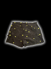 Load image into Gallery viewer, 1X Black corduroy high waist cutoff shorts w/ green &amp; yellow smiling floral embroidery, pockets, belt loops, &amp; button/zipper closure
