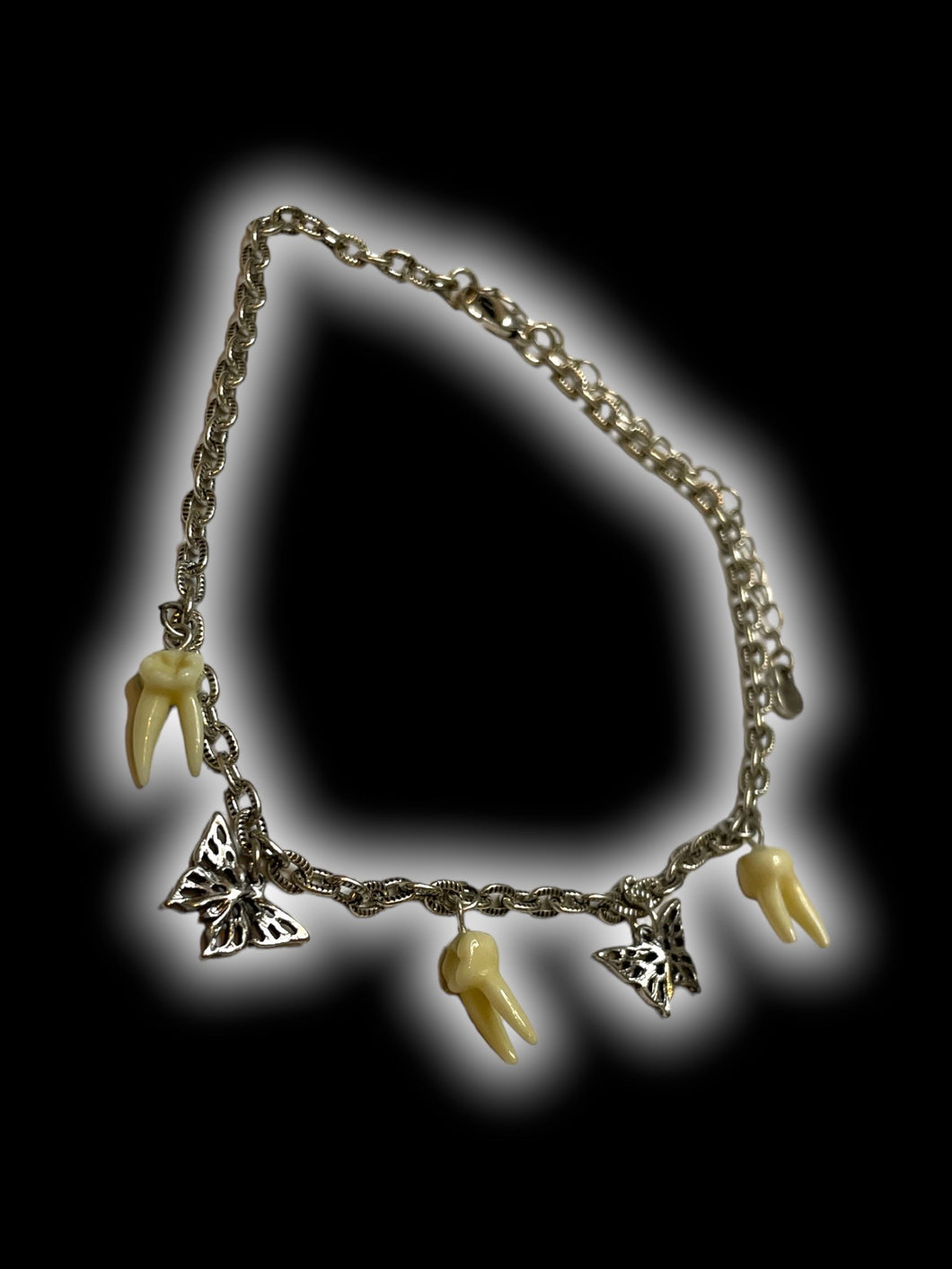 Silver-like choker necklace w/ butterfly & teeth charms