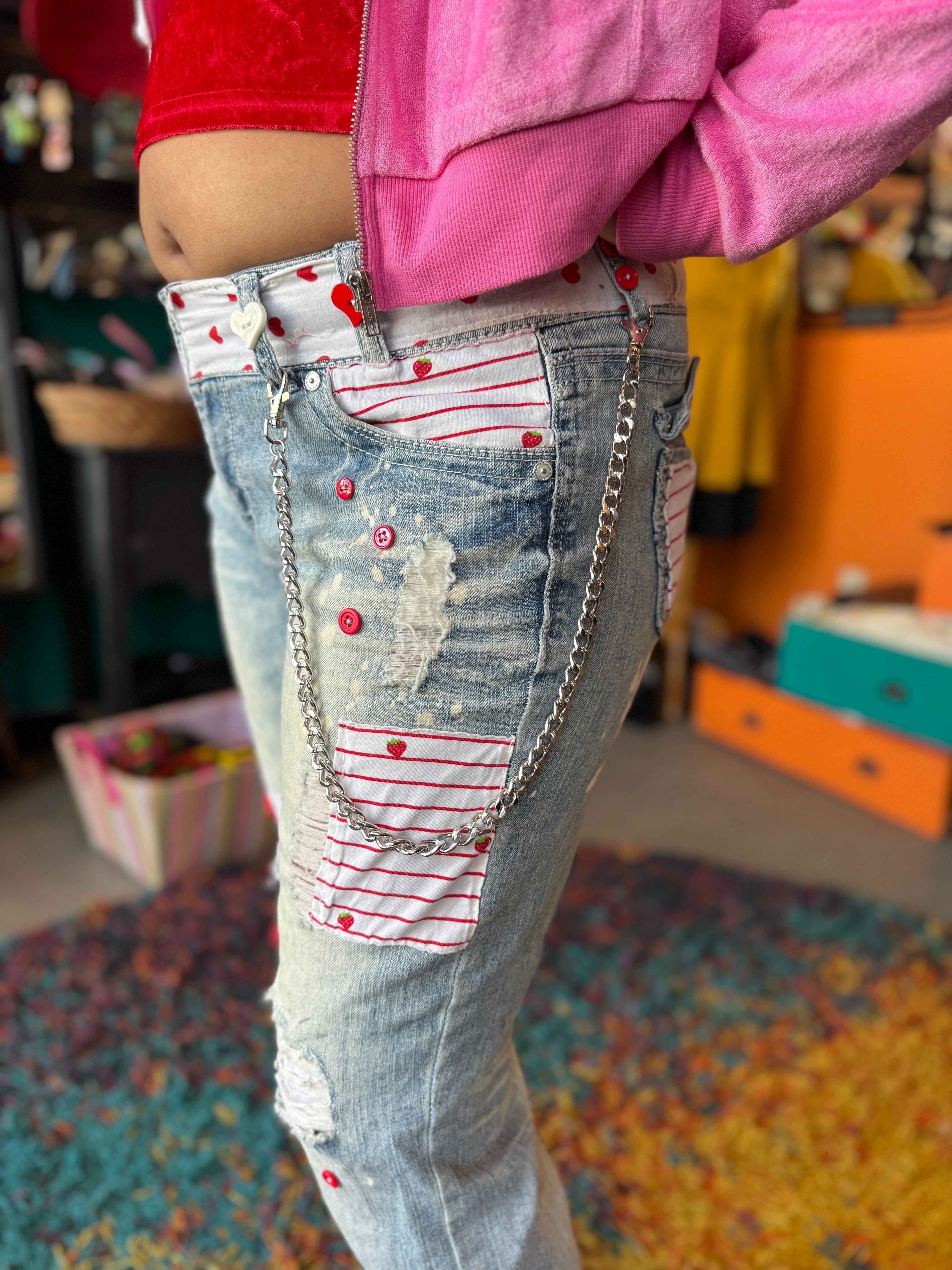L WallFlower acid wash ripped jeans with silver wallet chain,  white and red buttons, strawberry/heart/striped fabric patches throughout