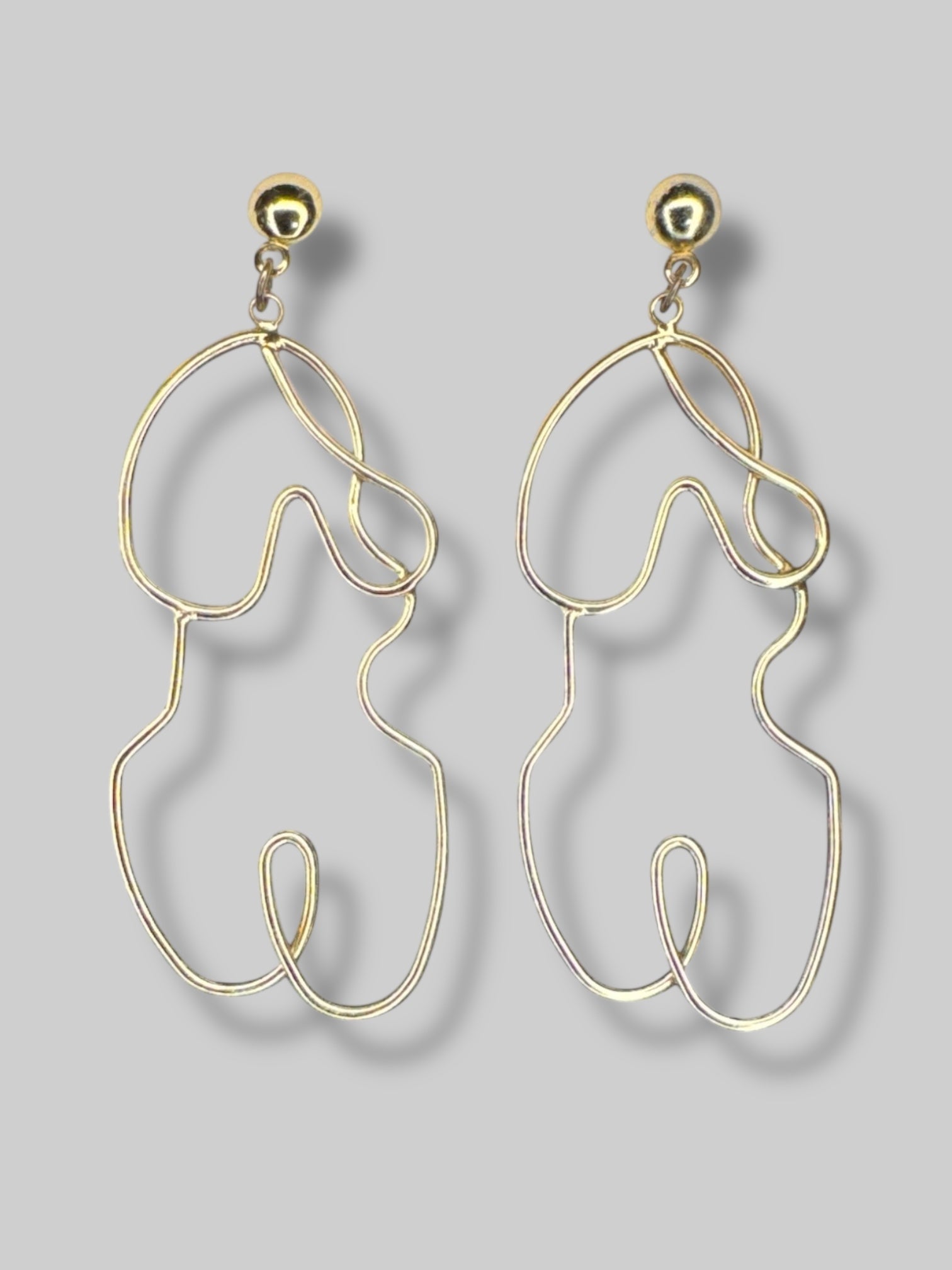 Gold tone wire wrap earrings in shape of body