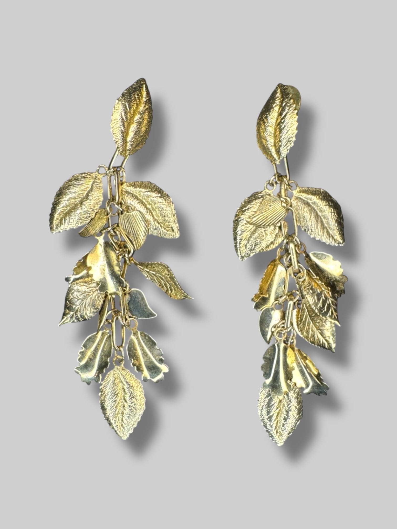 Gold tone dangley textured leaf earrings