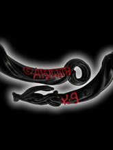 Load image into Gallery viewer, Black latex ornate pattern red stone necklace w/ arrow clasp, box, &amp; care instructions
