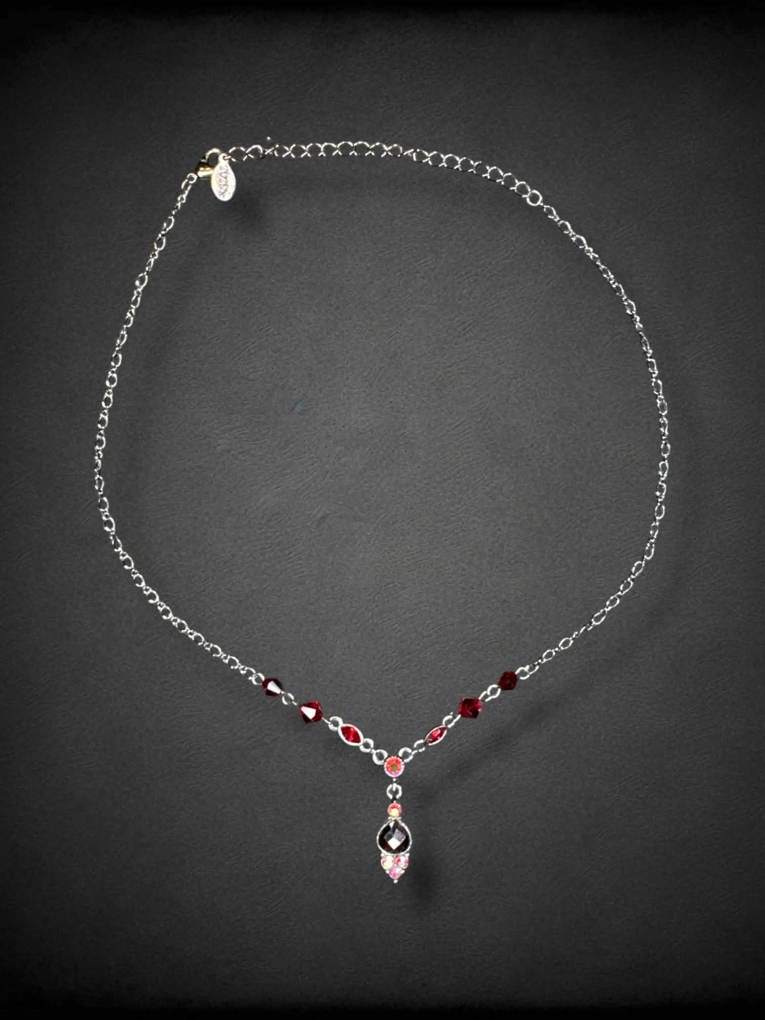 Dark grey chain necklace with red beading and bedazzled pendant