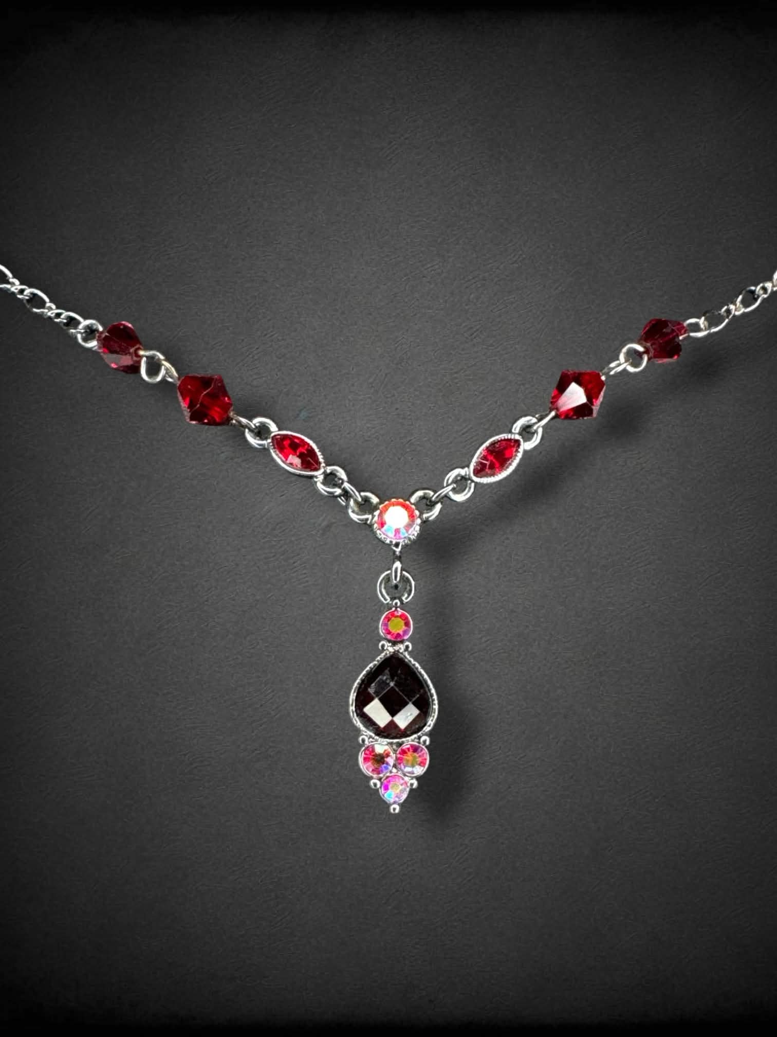 Dark grey chain necklace with red beading and bedazzled pendant