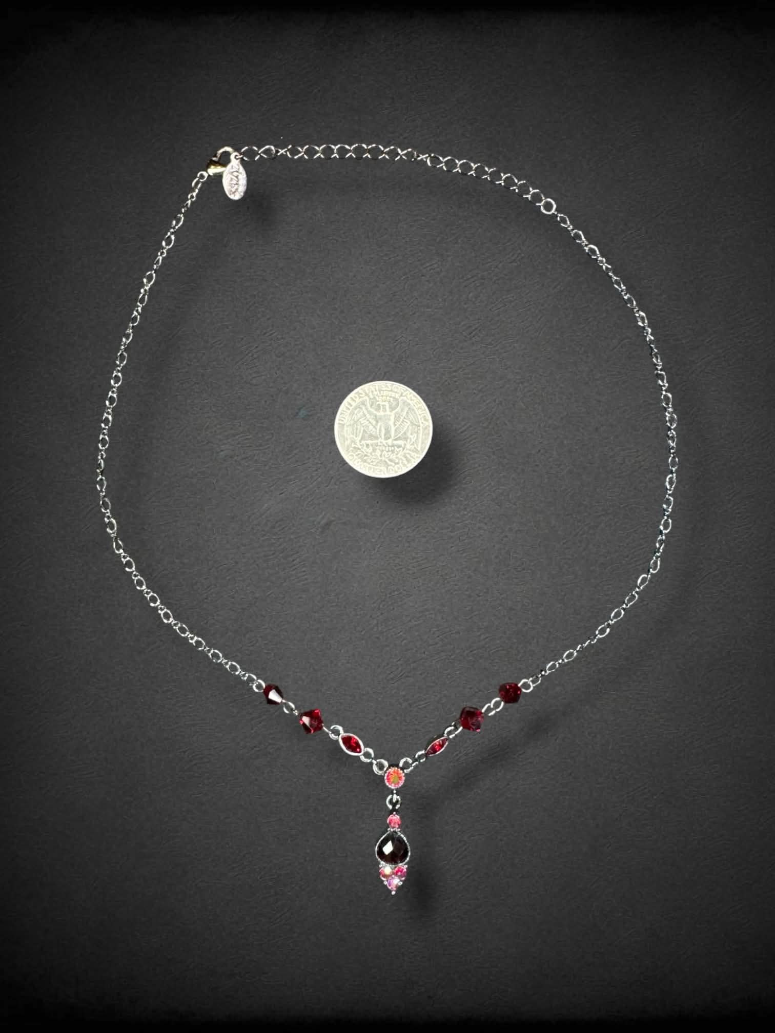 Dark grey chain necklace with red beading and bedazzled pendant