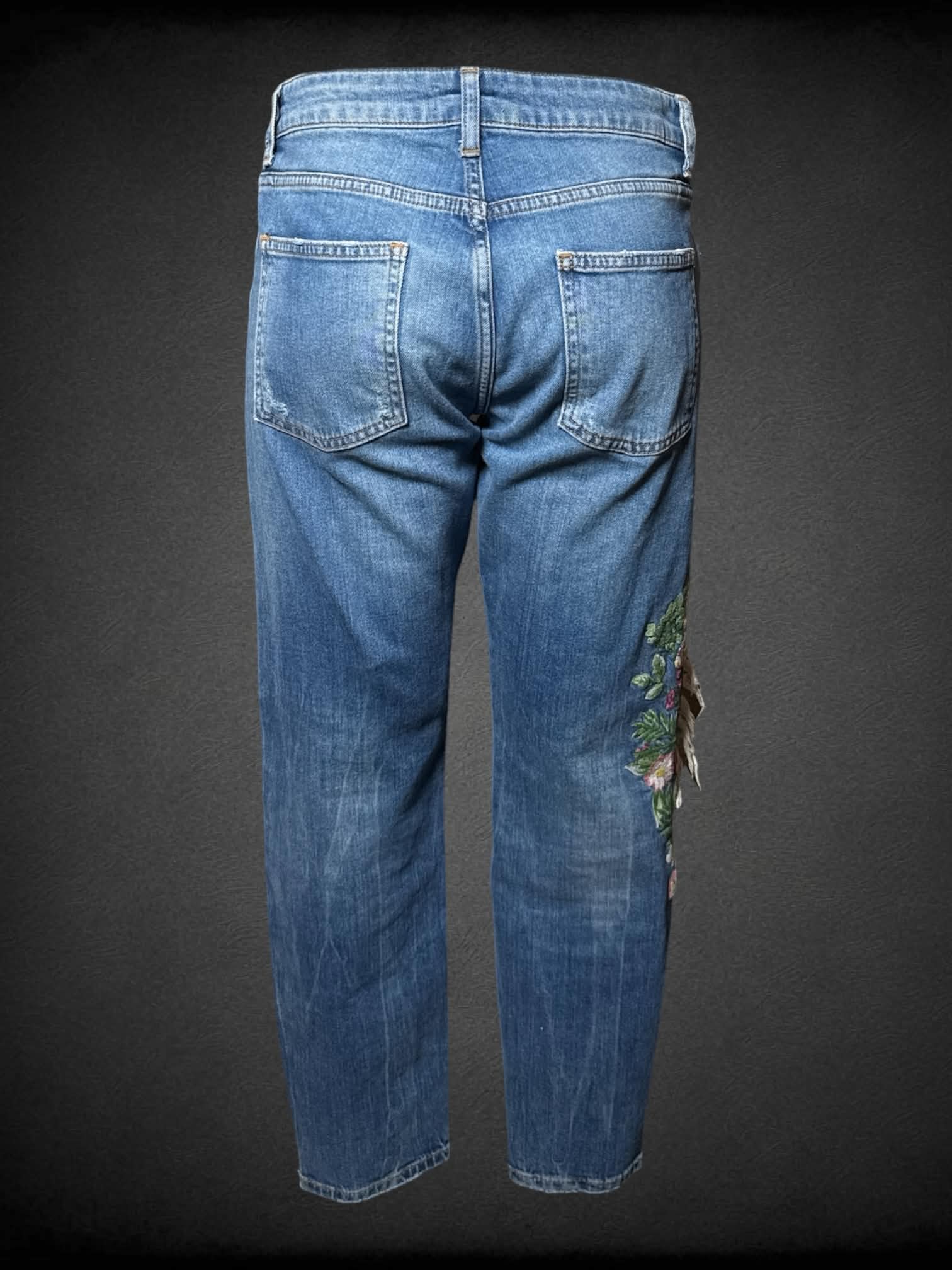 L Zara blue distressed jeans with embroidered floral design, and cutout of a face on knee