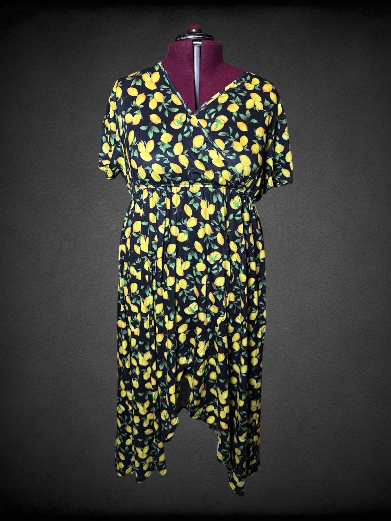 3X black dress with lemon pattern, and asymmetrical cut on front