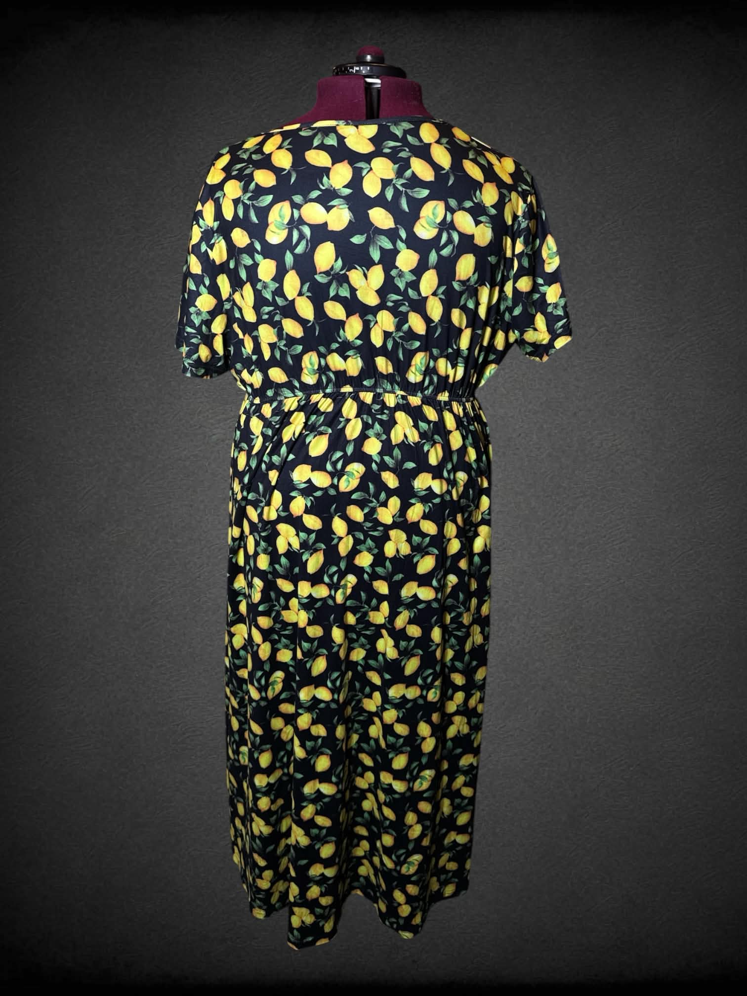3X black dress with lemon pattern, and asymmetrical cut on front