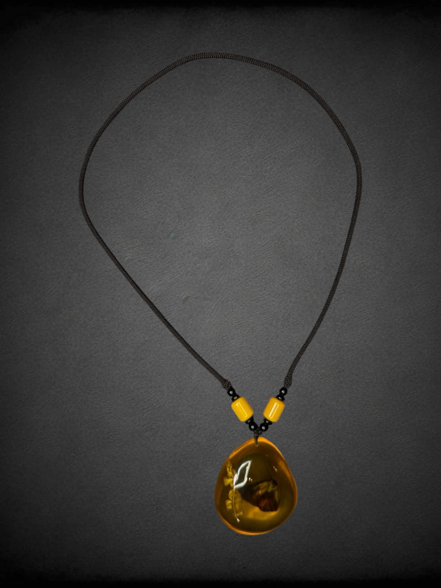 Black chord necklace with butterfly amber charm