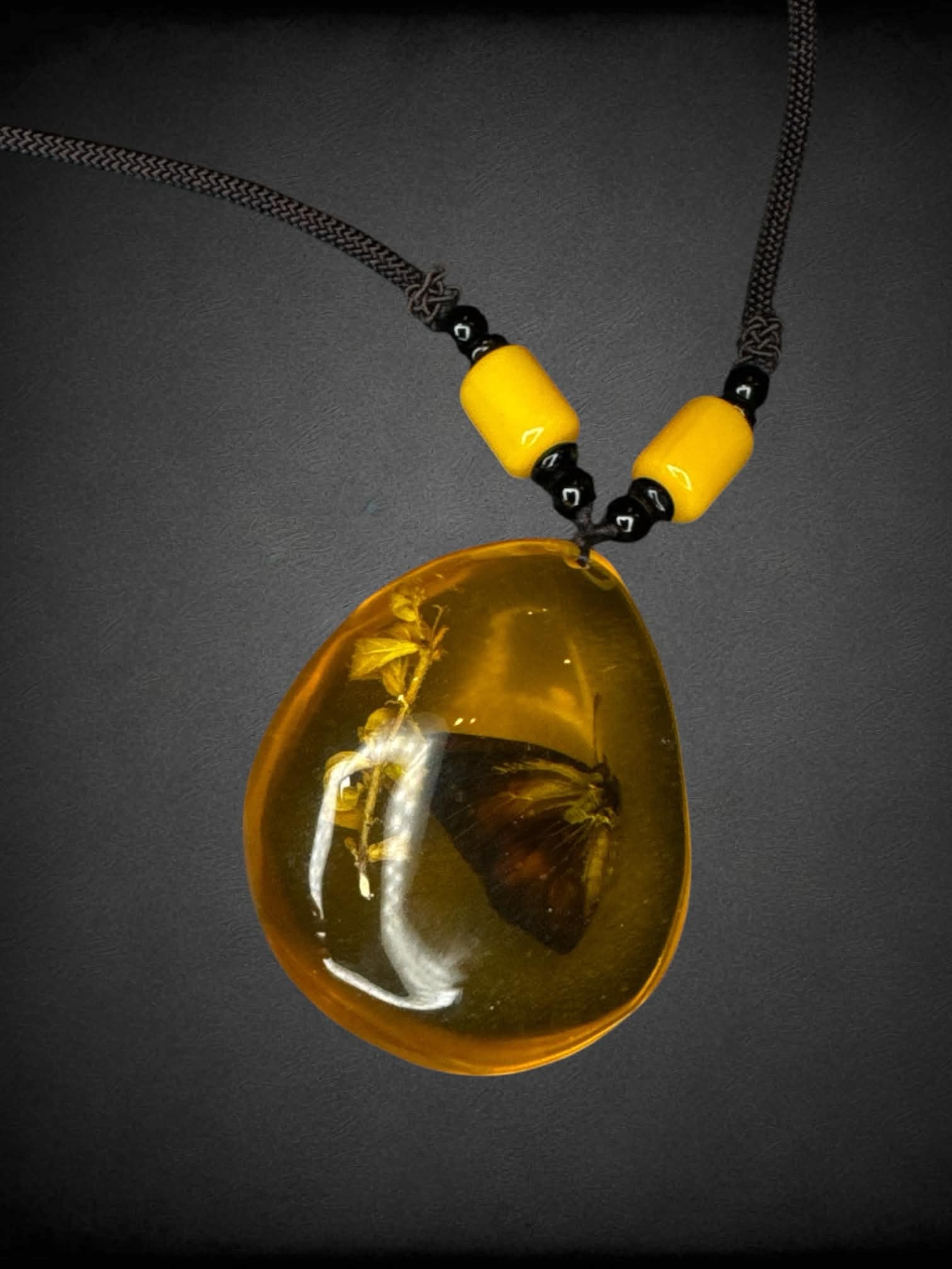 Black chord necklace with butterfly amber charm