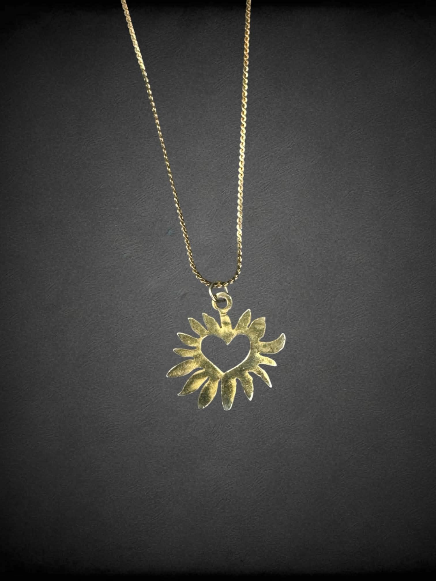 Gold chain necklace with sun heart charm