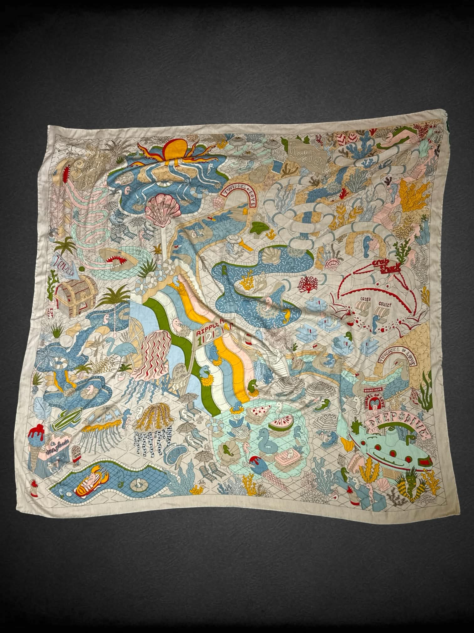 White tapestry with colorful aquatic design