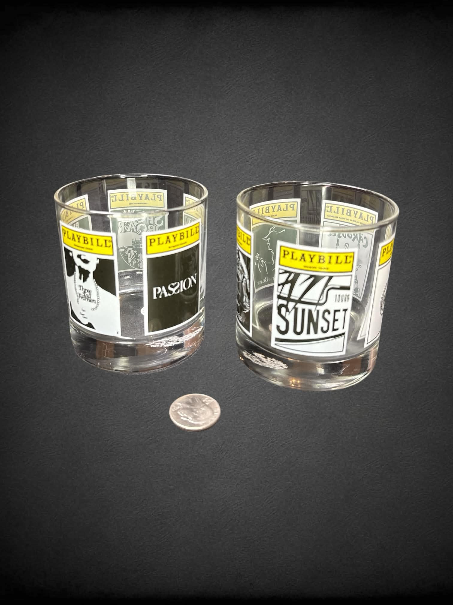 Playbill set-of-two drinking glasses with different “Playbill” posters wrapping around glass