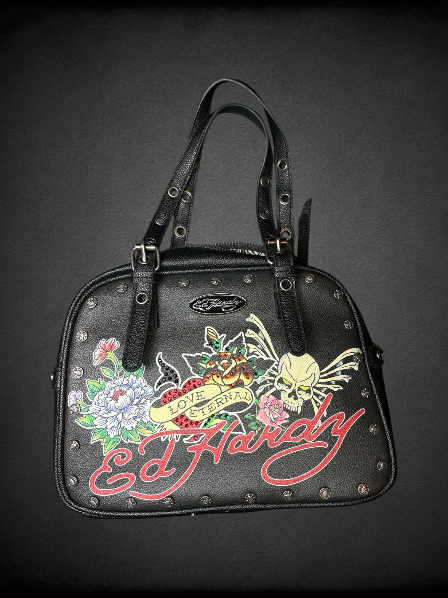 Ed Hardy black leather handbag with “Love Eternal” tattoo graphic on front, and “Go Hardy” writing on back, with zipper pocket