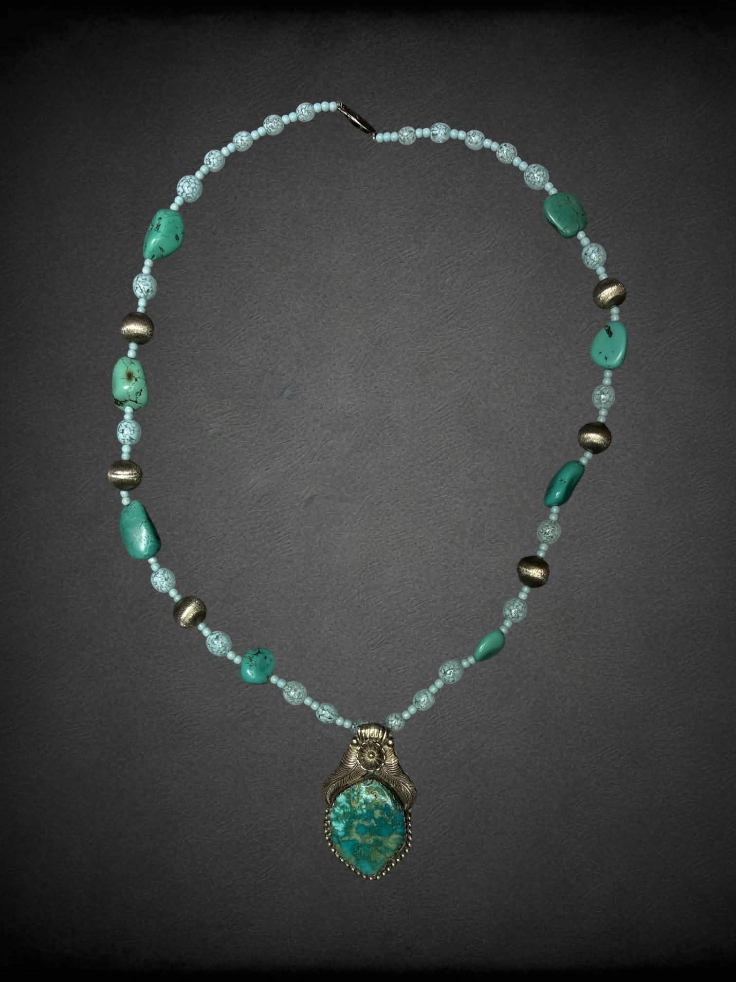 Blue beaded necklace with silver and blue stone charm