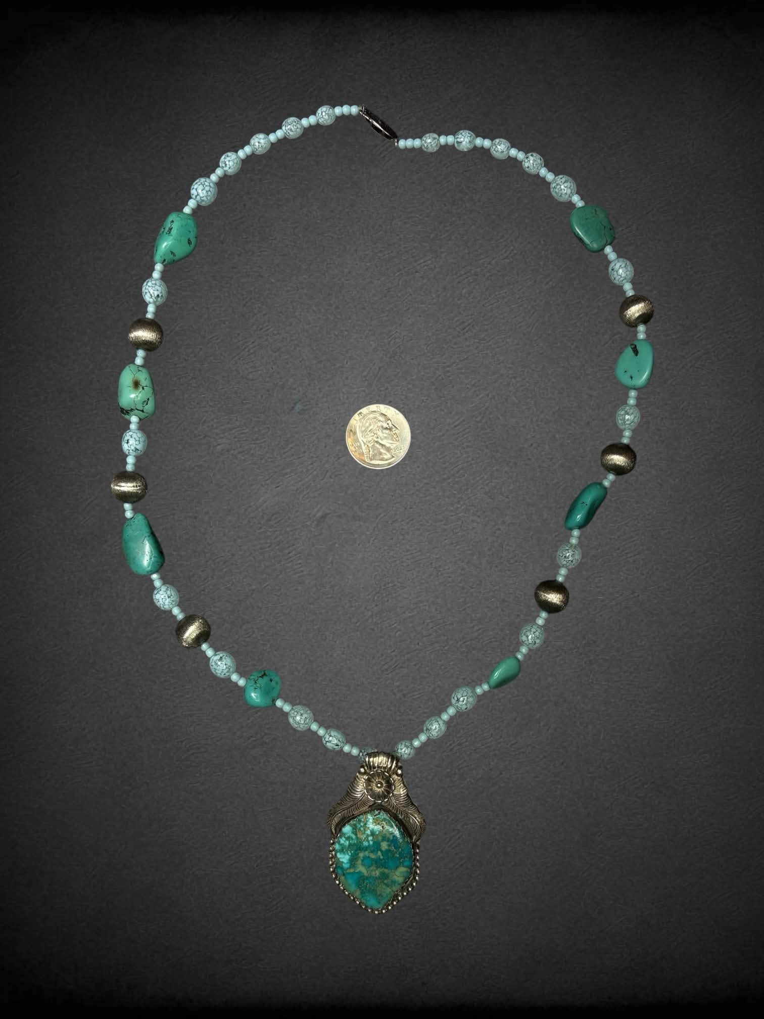 Blue beaded necklace with silver and blue stone charm