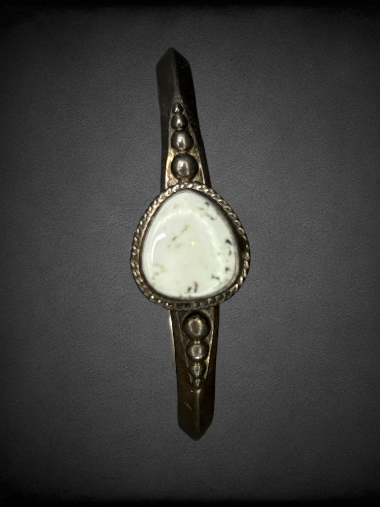 Small metal bangle with white stone