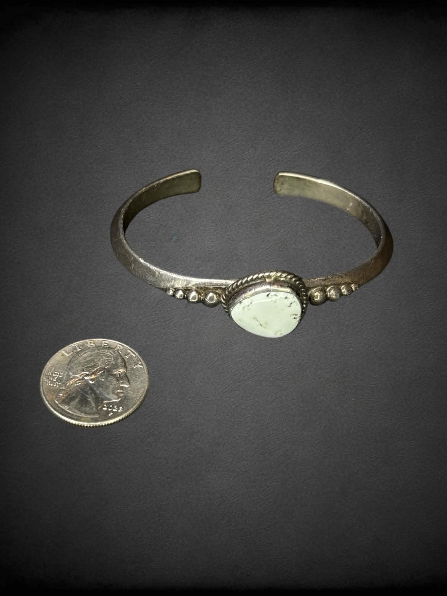 Small metal bangle with white stone