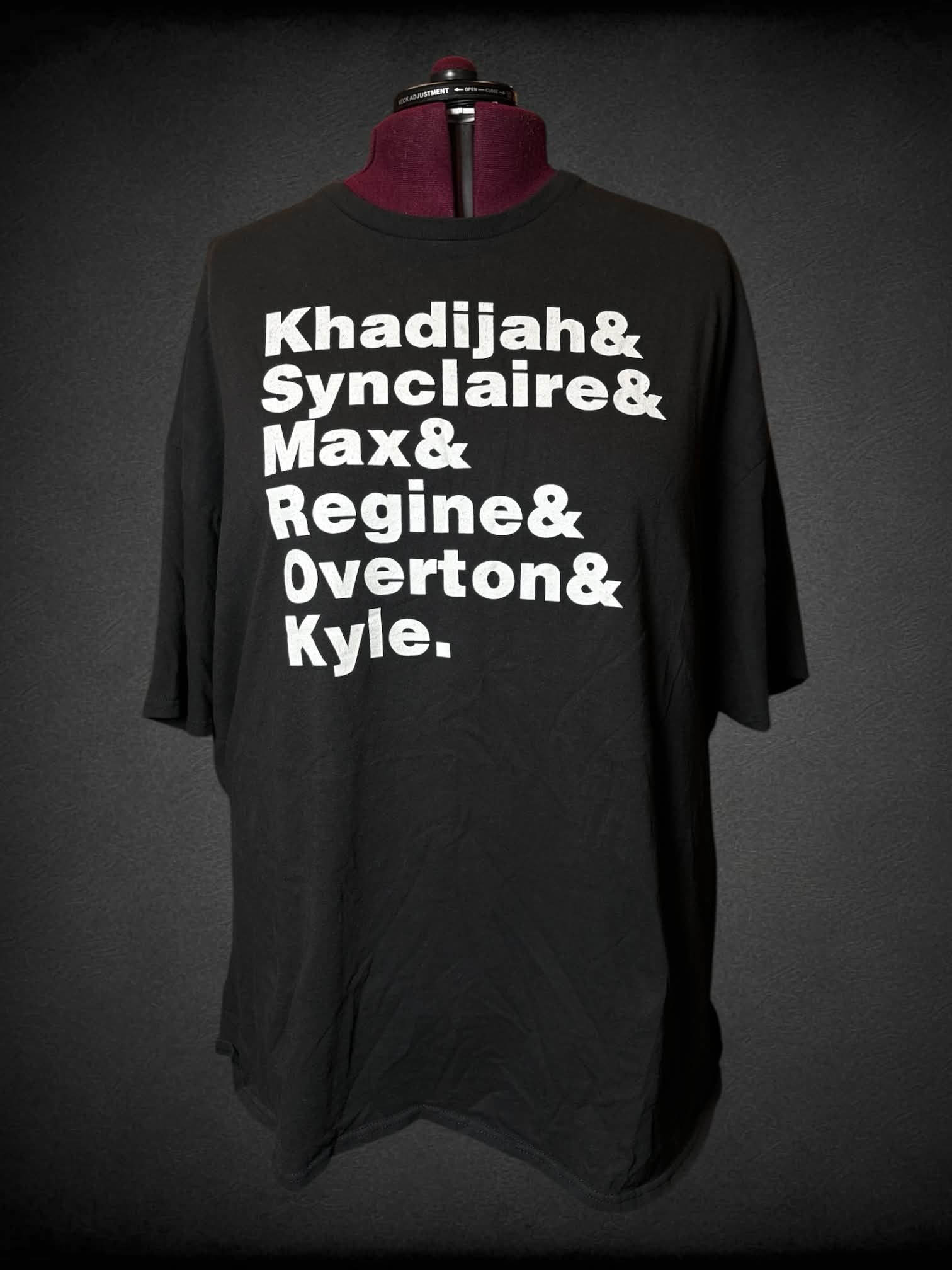5X Delta black t shirt with list of character names from the show “Living Single” on front