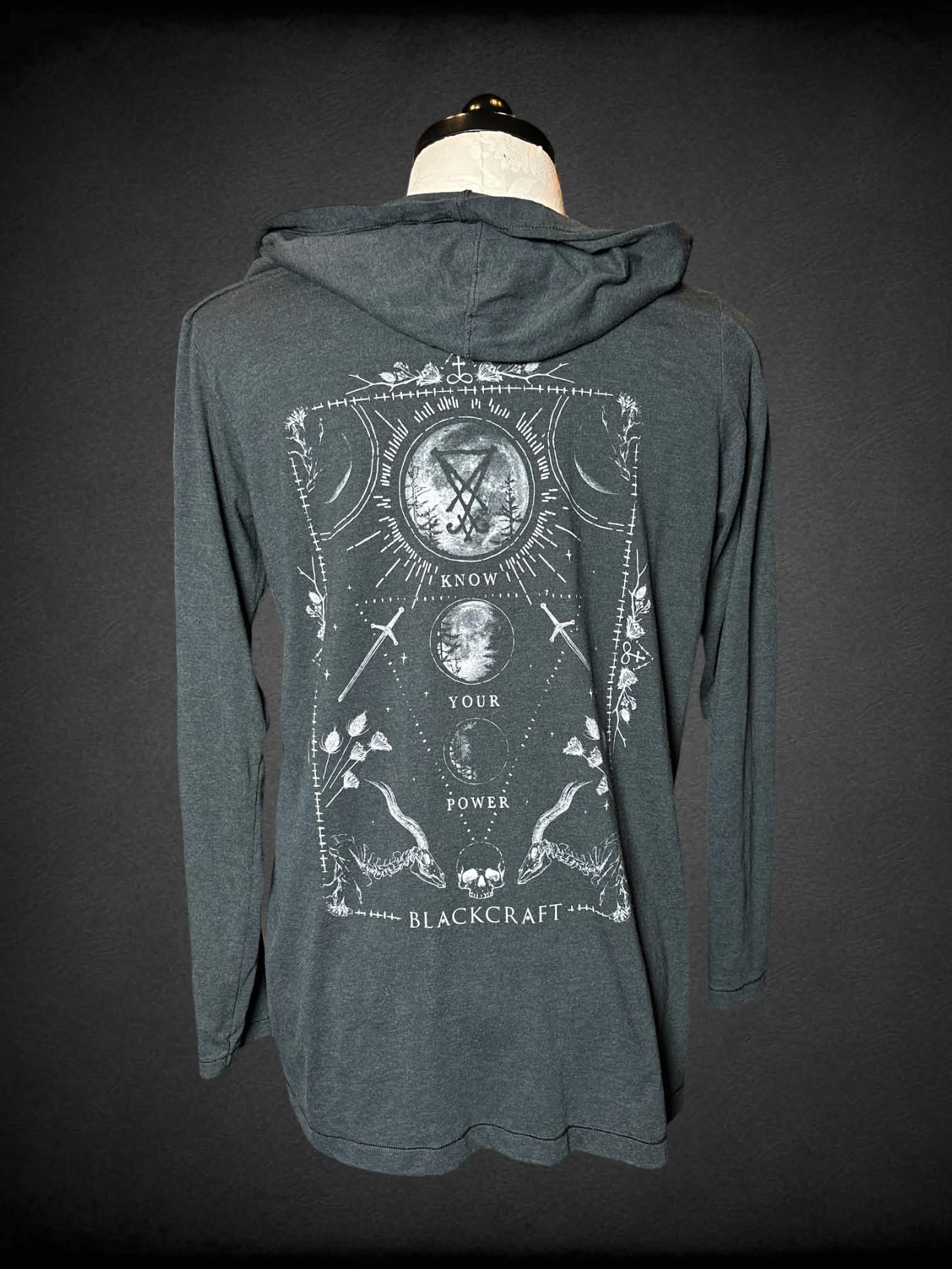 0X Black Craft grey hooded cardigan with “Know Your Power” moon and sword graphic on back