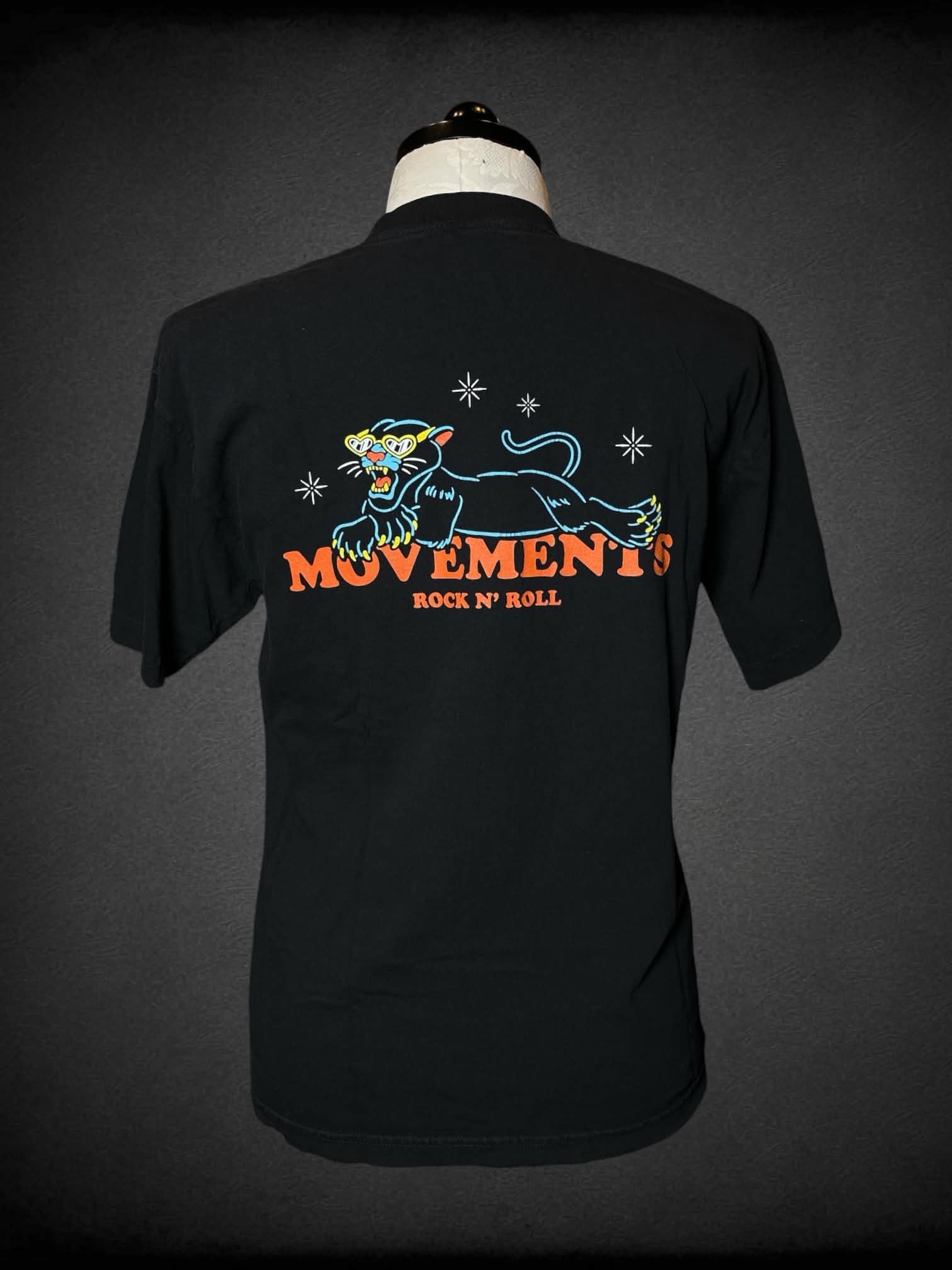 1X Los Angeles Apparel black t shirt with “Movements” band writing on front, and panther graphic on back