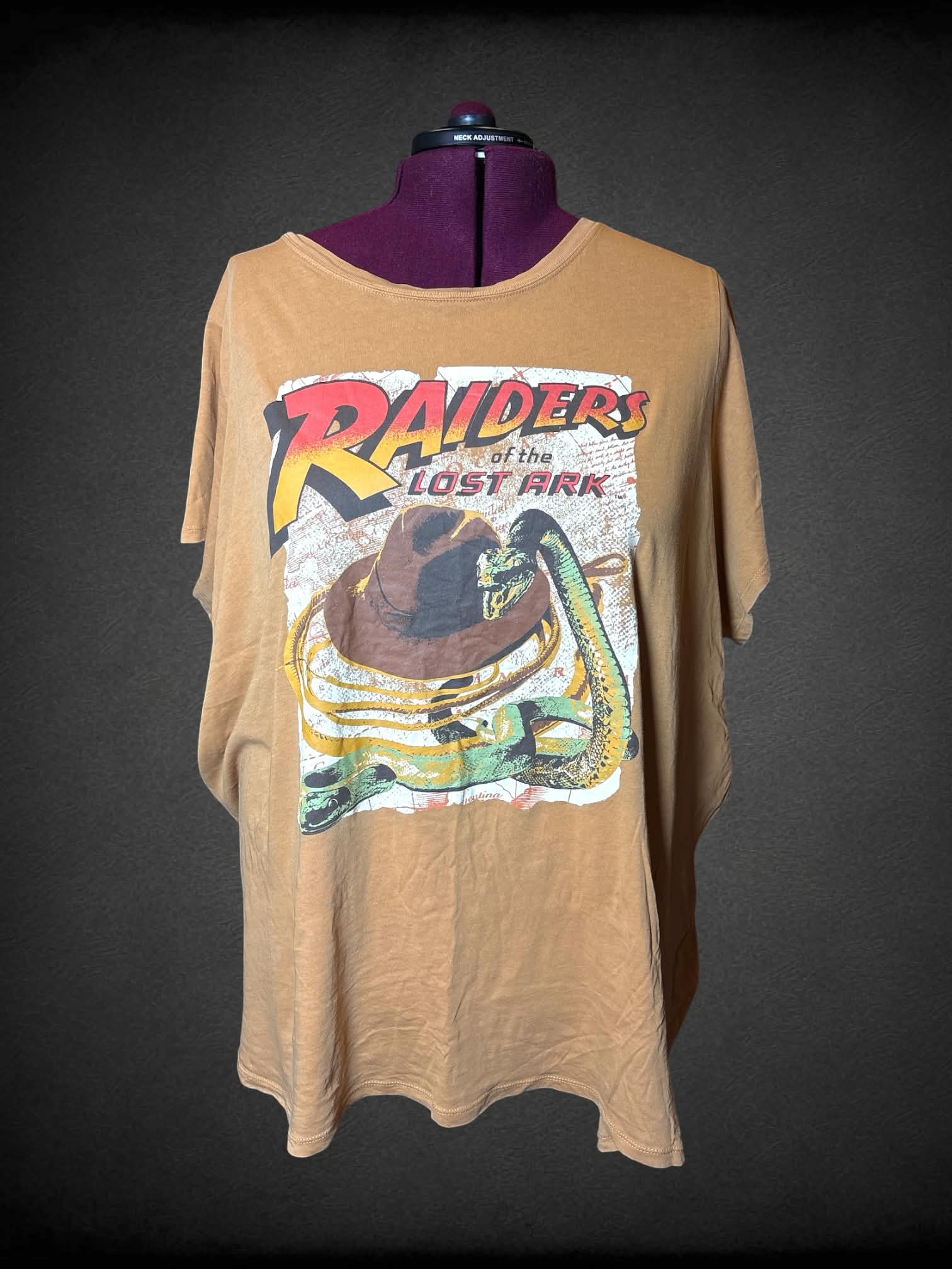 7X Indiana Jones brown t shirt with “Raiders of The Lost Ark” snake graphic on front