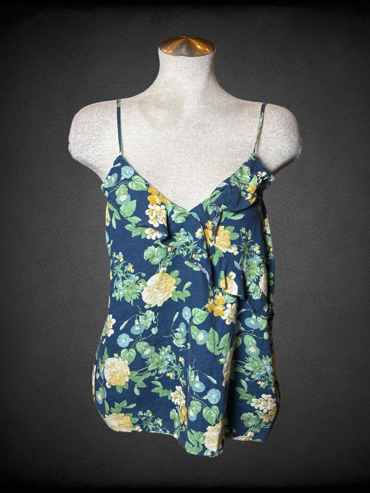 L Old Navy blue cami top with floral pattern, and asymmetrical ruffle design on front