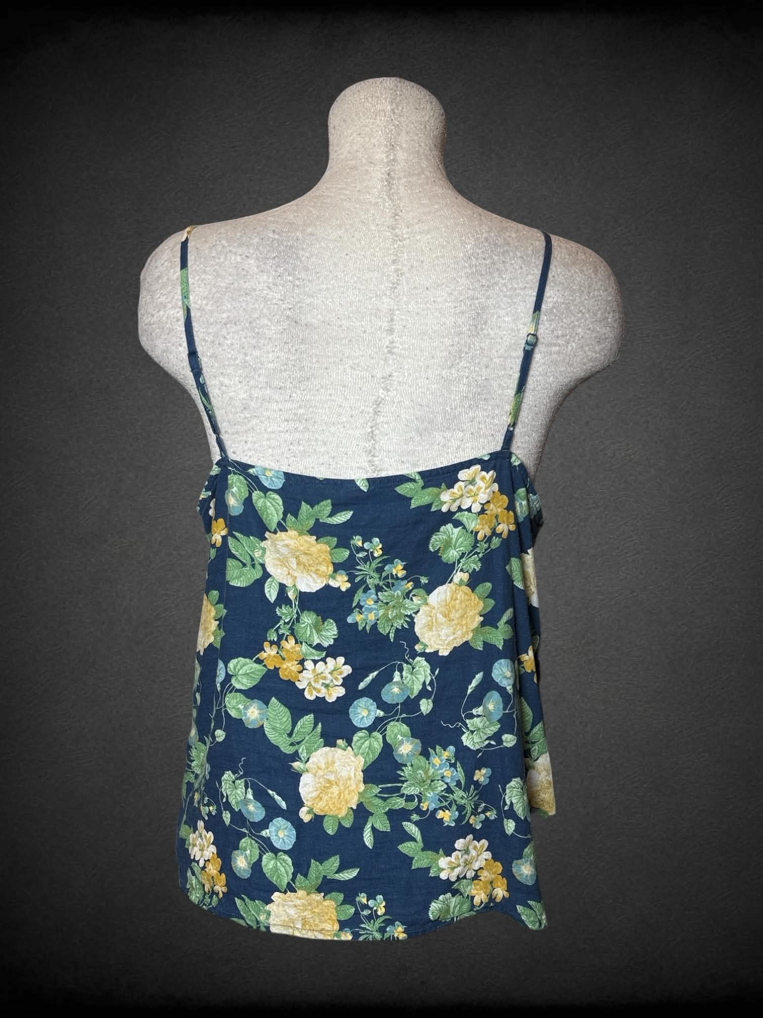 L Old Navy blue cami top with floral pattern, and asymmetrical ruffle design on front