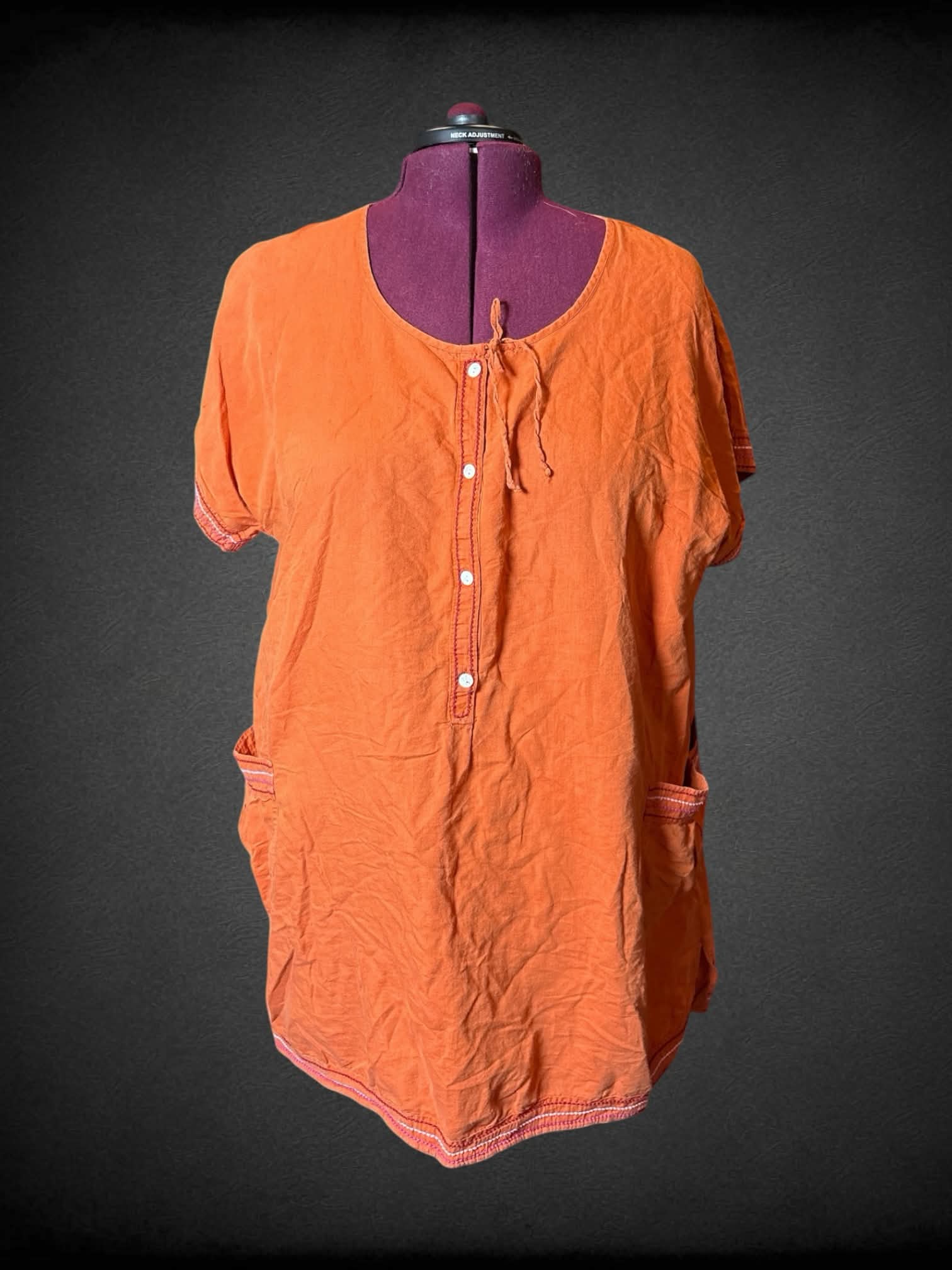 2X Gudren Sjoden Orange dress with buttons on front, pockets, and sewn pattern on hemline