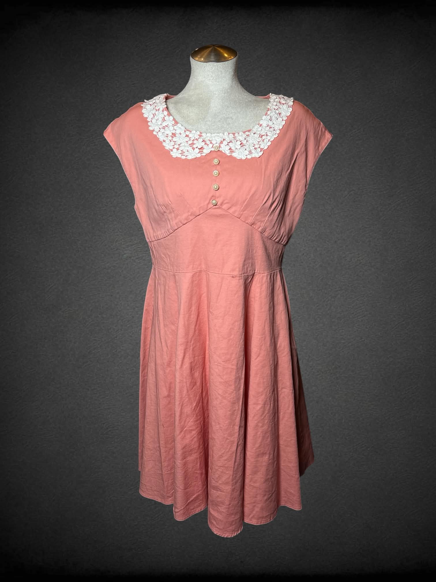 L Aranee pink short dress with decorative buttons on front, lace collar, and zipper on back