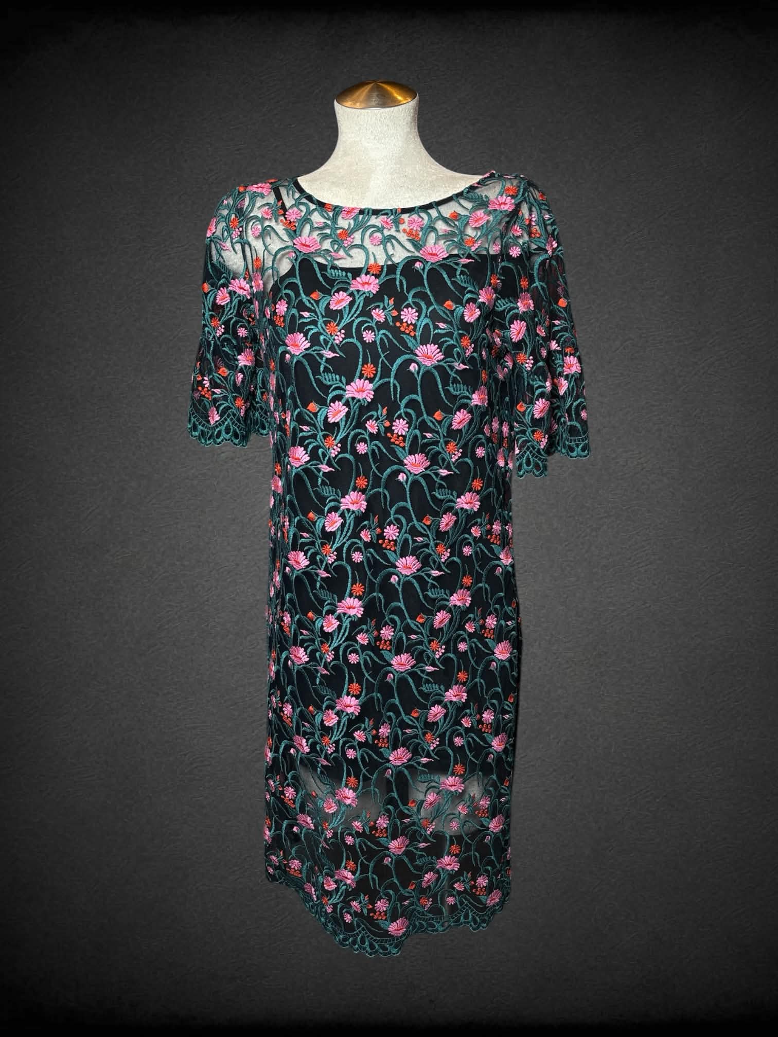 L Moulinette Soeurs black short dress with green mesh overlayer, and embroidered flower pattern