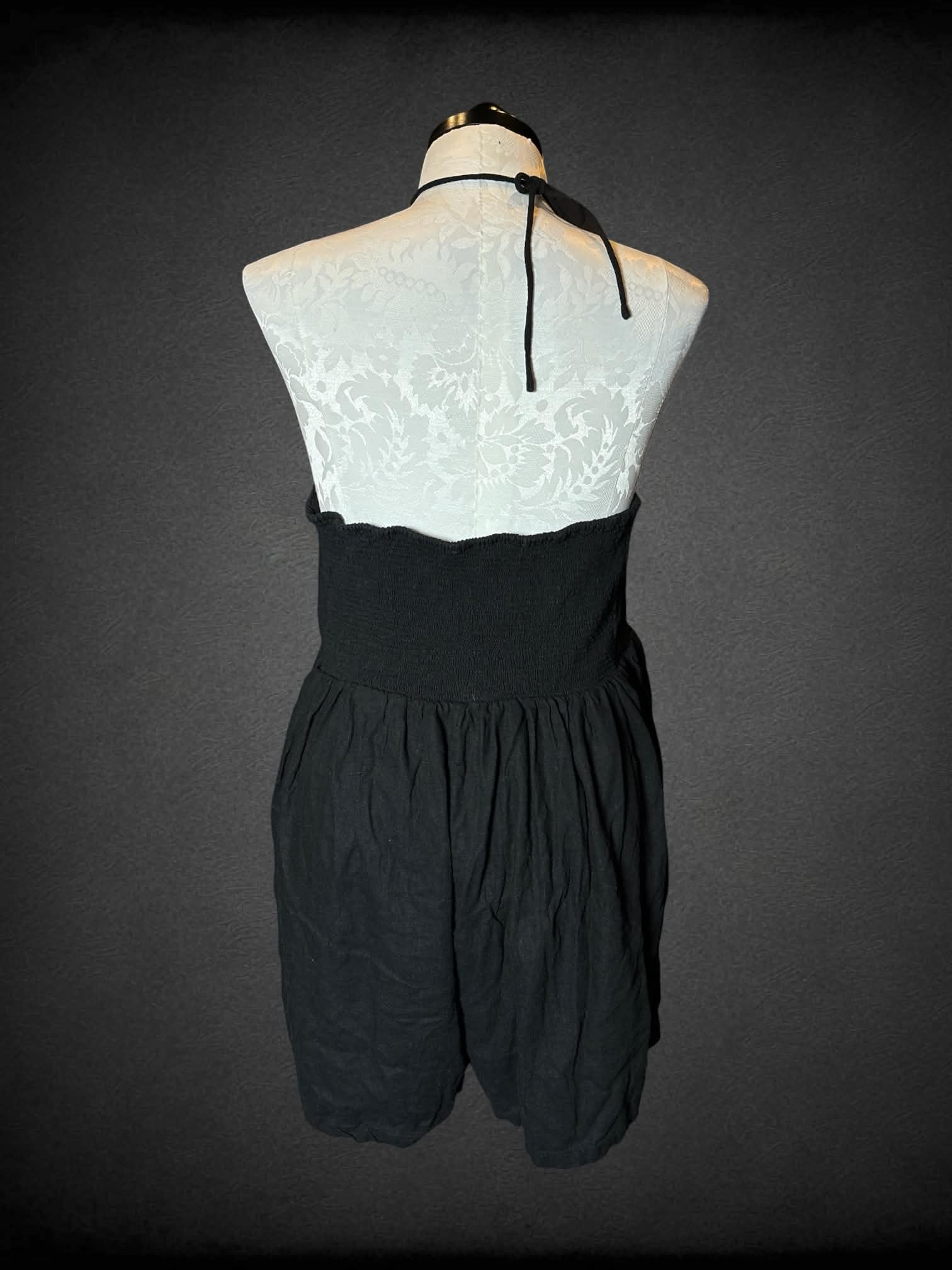 1X Old Navy black halter jumpsuit with adjustable tie neckline and hoop detailing on front