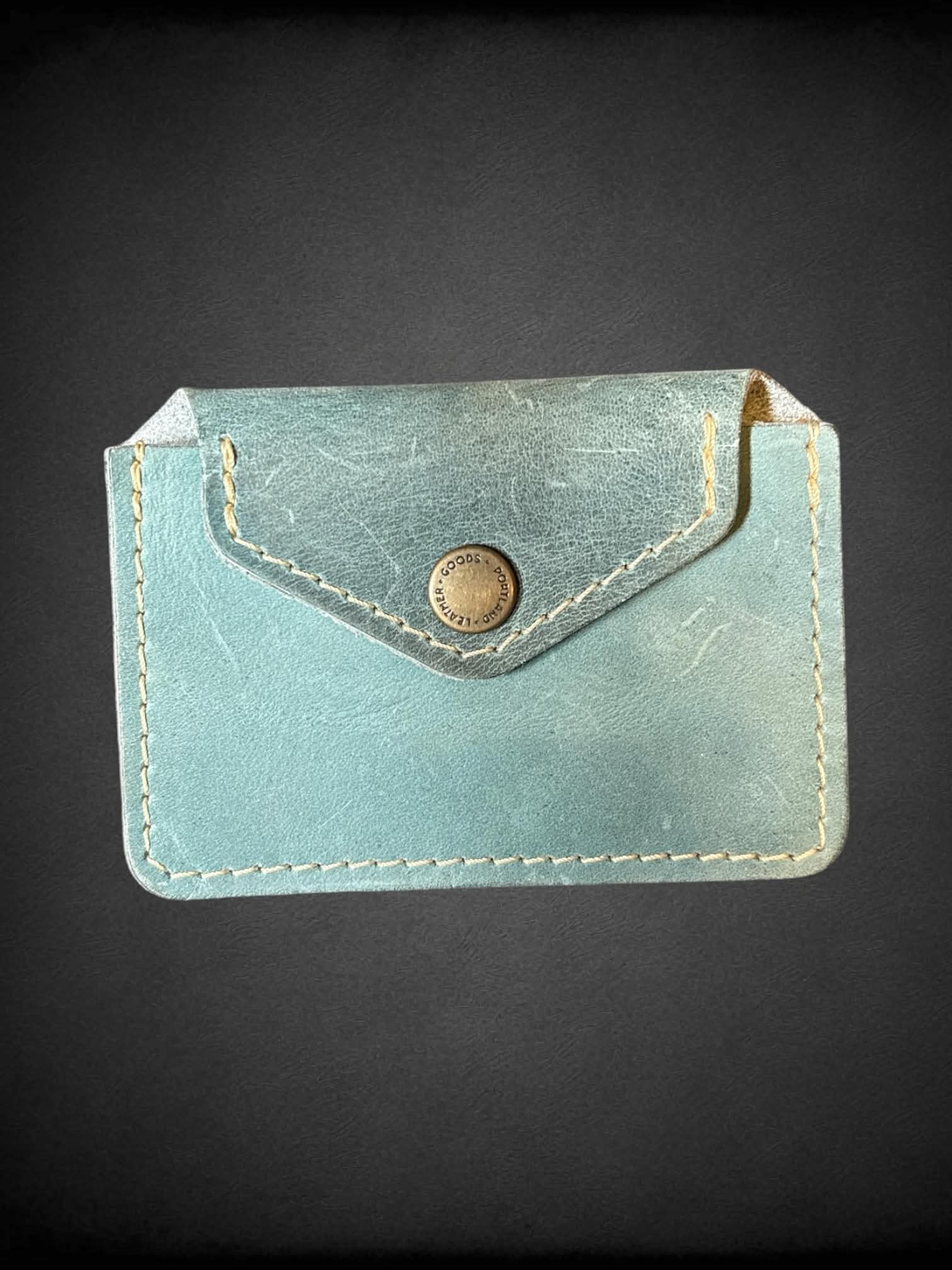 Blue leather wallet with button pocket