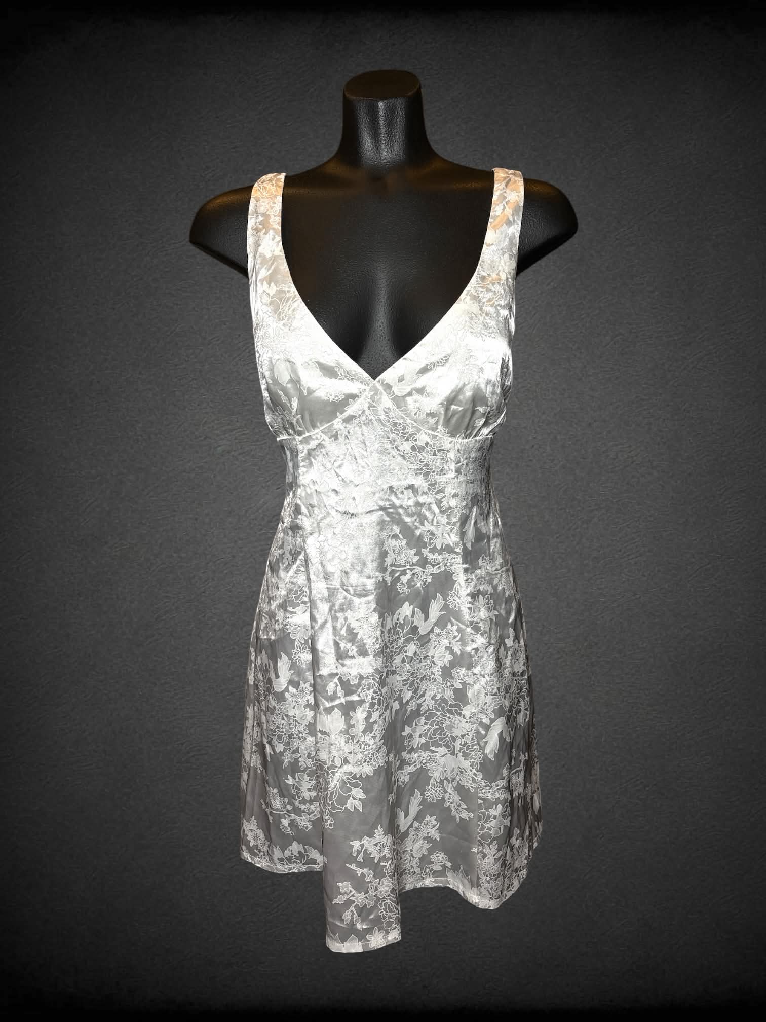 S Cider white short dress with cutout on back, floral embroidery pattern, and zipper on back