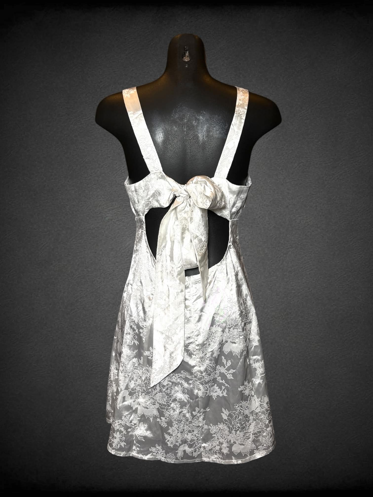 S Cider white short dress with cutout on back, floral embroidery pattern, and zipper on back