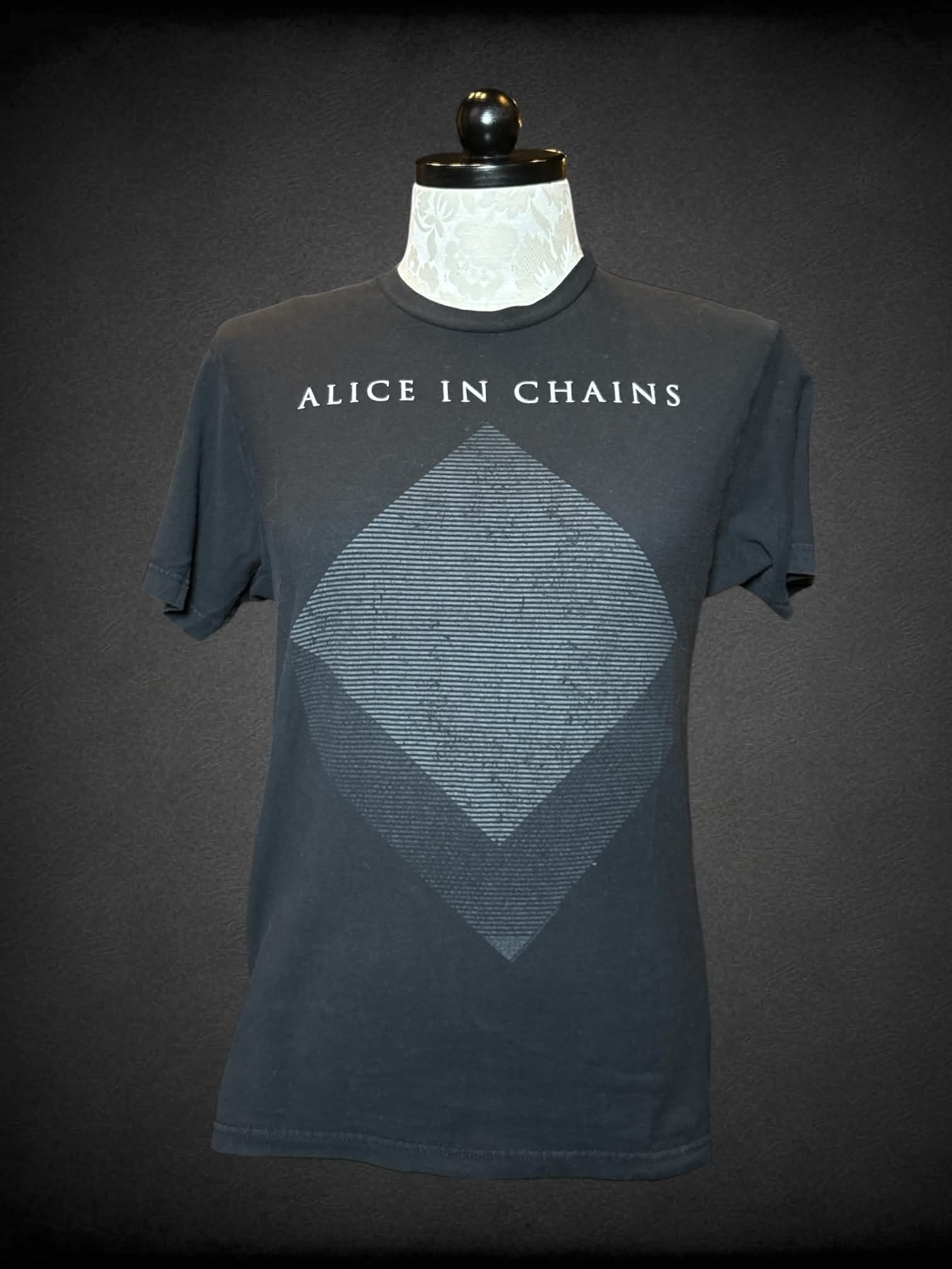 1X Tultex black t shirt with “Alice in Chains” band name with diamond shaped graphic on front