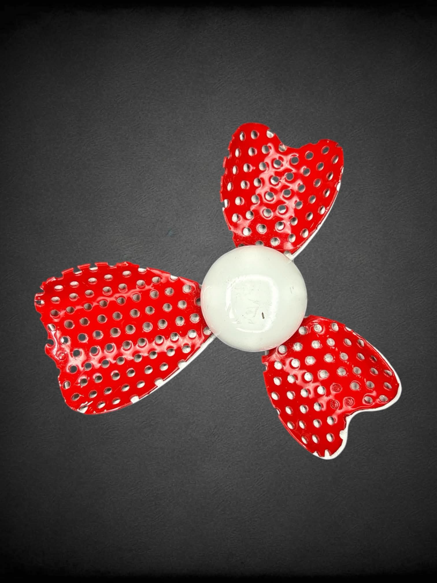 Red metal broach with white center