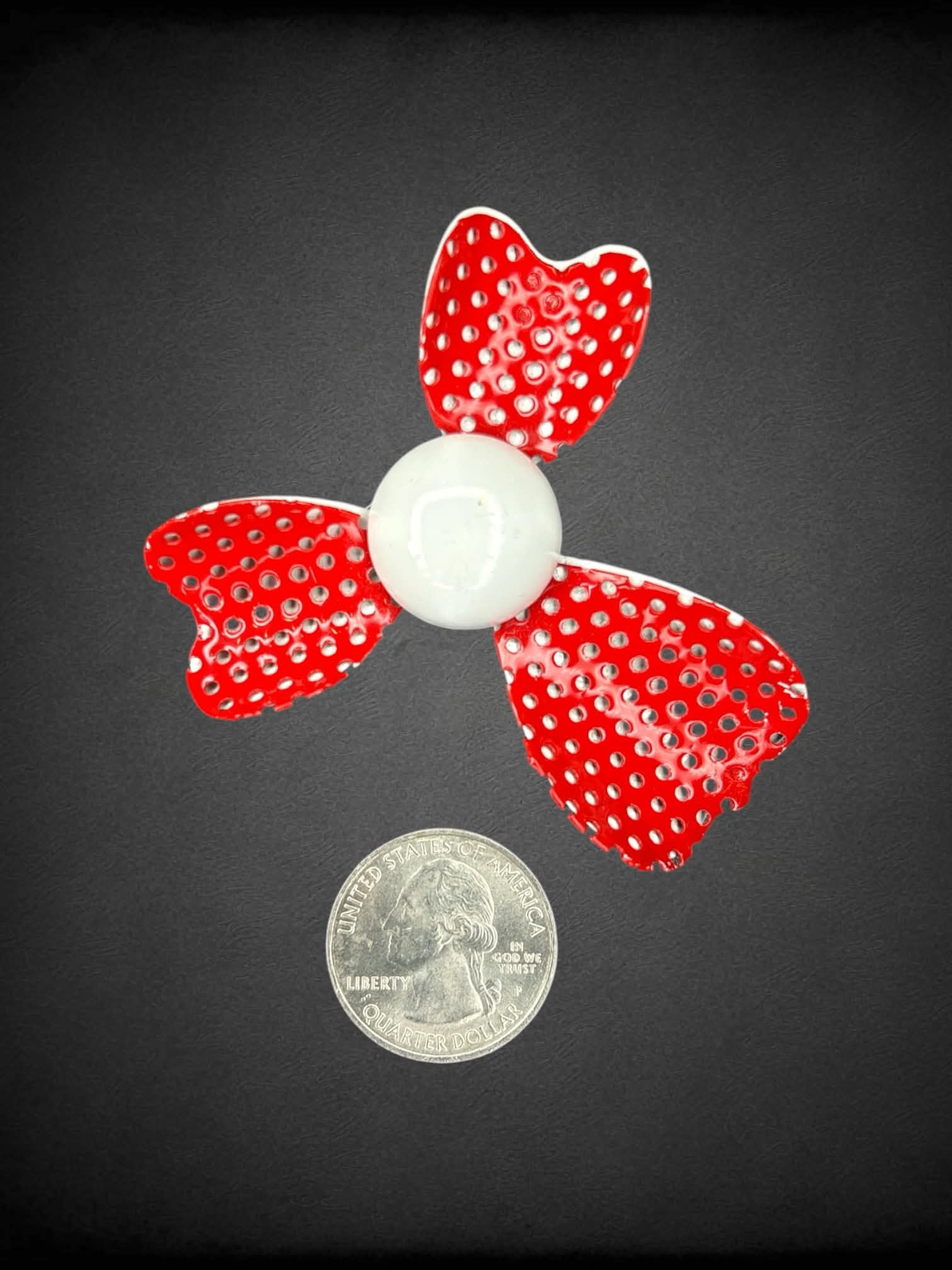 Red metal broach with white center
