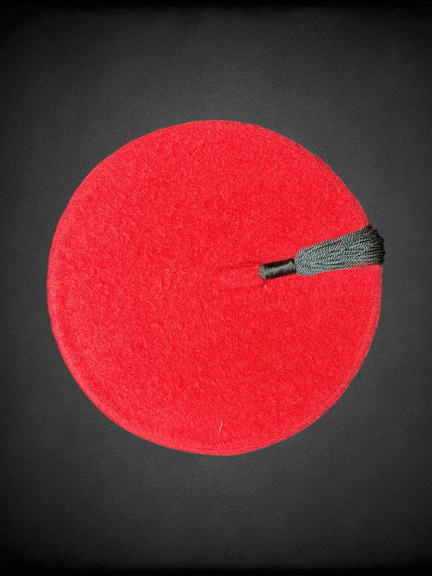 Red fez with black tassel