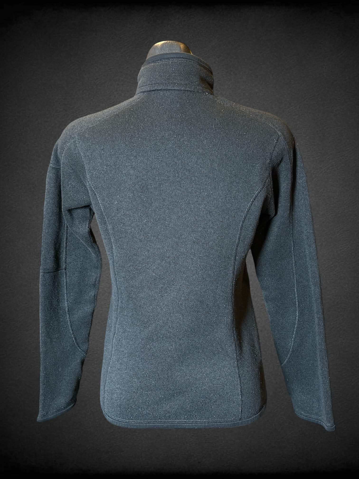 M Patagonia black turtleneck jacket with zipper on front, and zipper pocket on sleeve