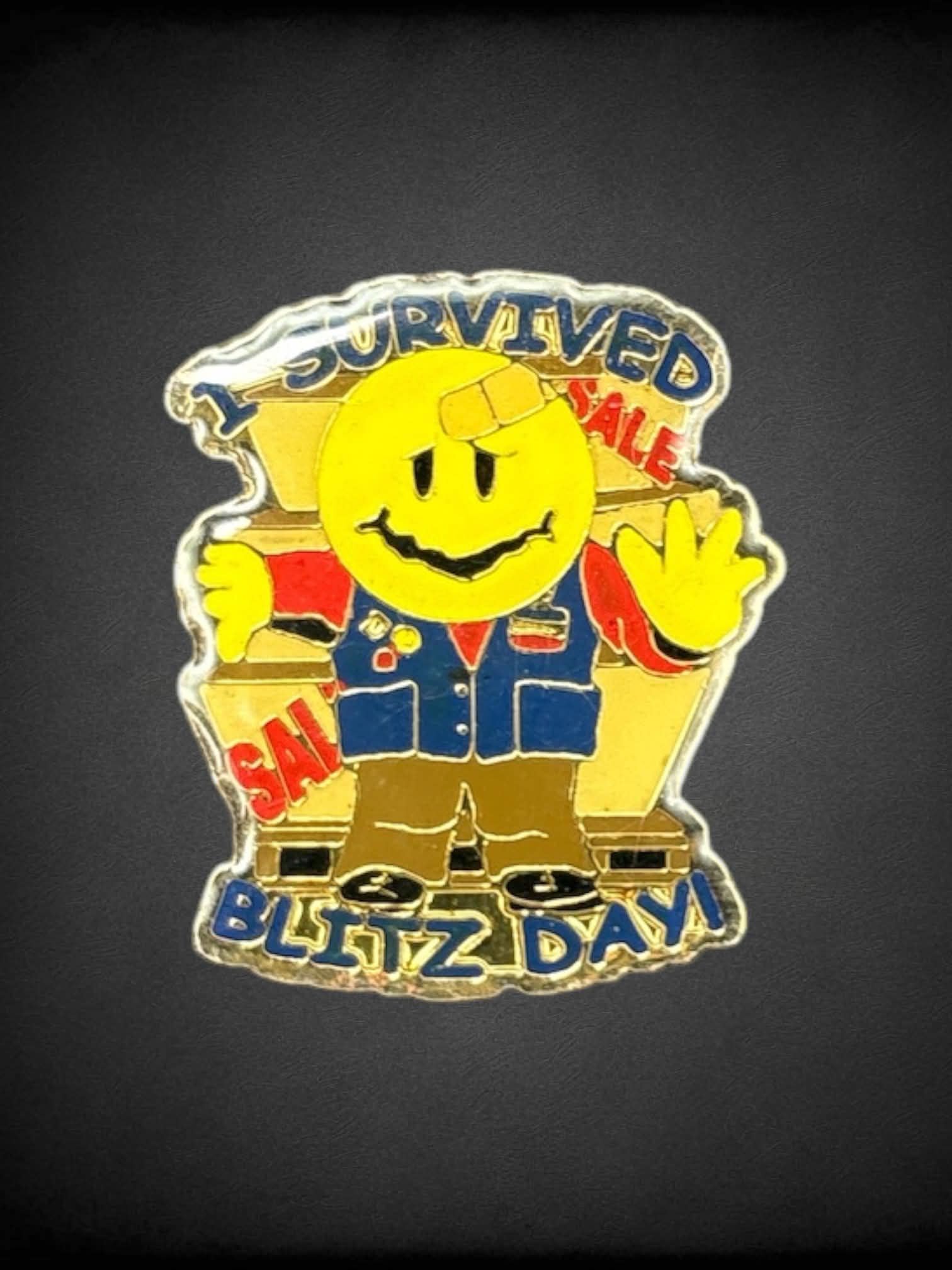 Gold “I Survived Blitz Day!” smiley face enamel pin