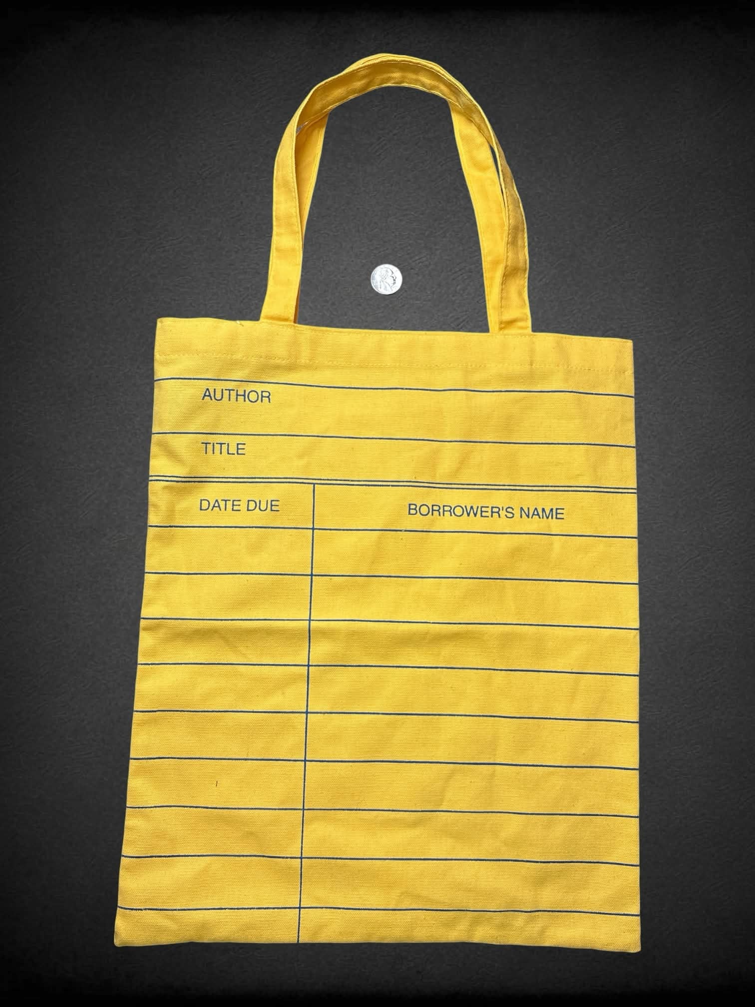 Out of Print NWT yellow tote bag with library book due date design
