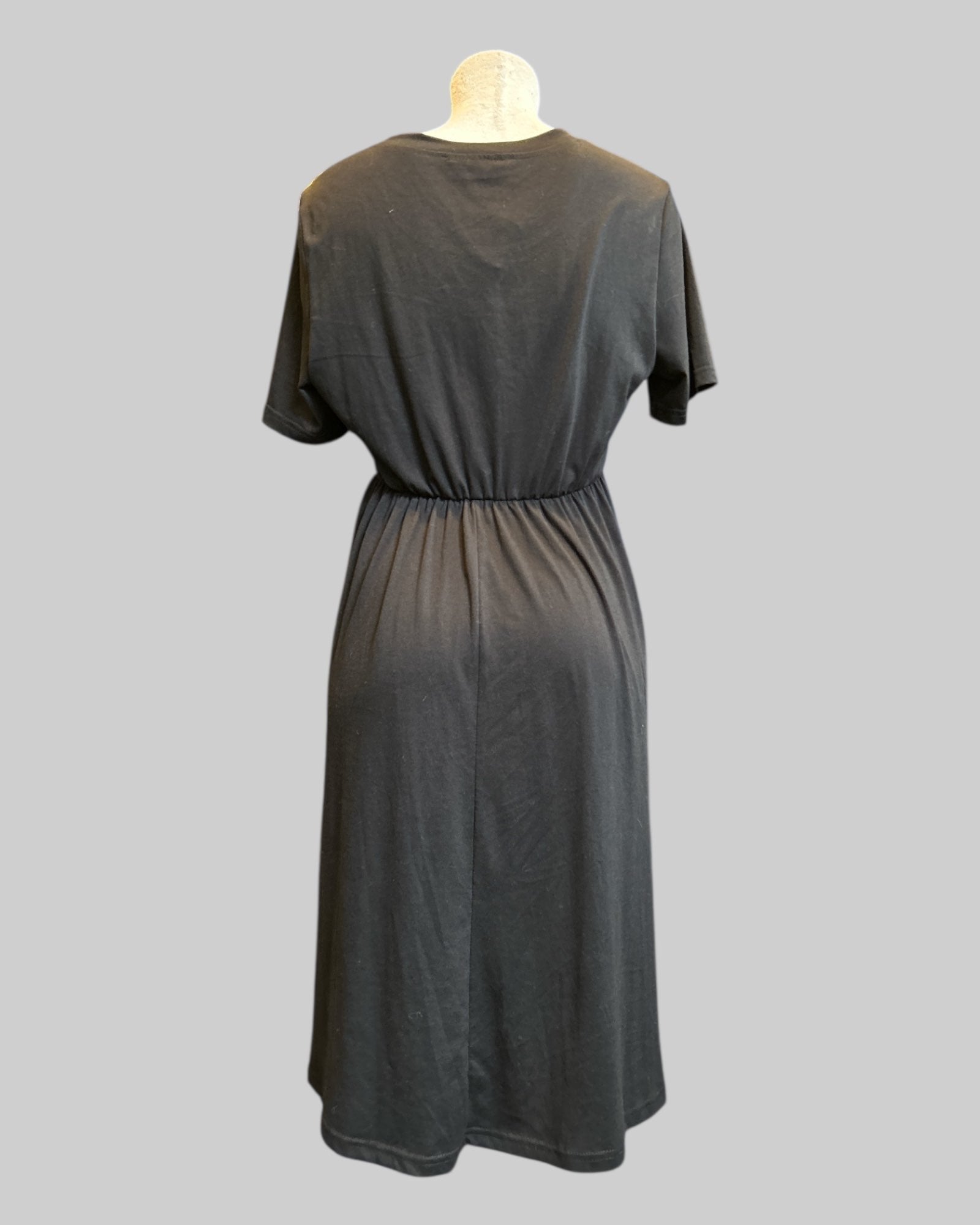L black stretchy and flowy dress with jack o lantern chest cutout, buttons, and pockets