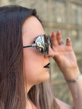 Load image into Gallery viewer, Black &amp; silver circular sunglasses w/ ram head sides, &amp; hooked arms
