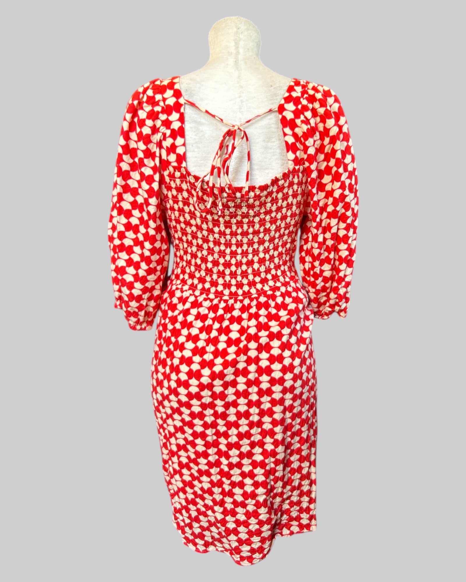 1X stretchy flowy red white geometric patterned dress with shirring in front and back, balloon sleeves, and pockets