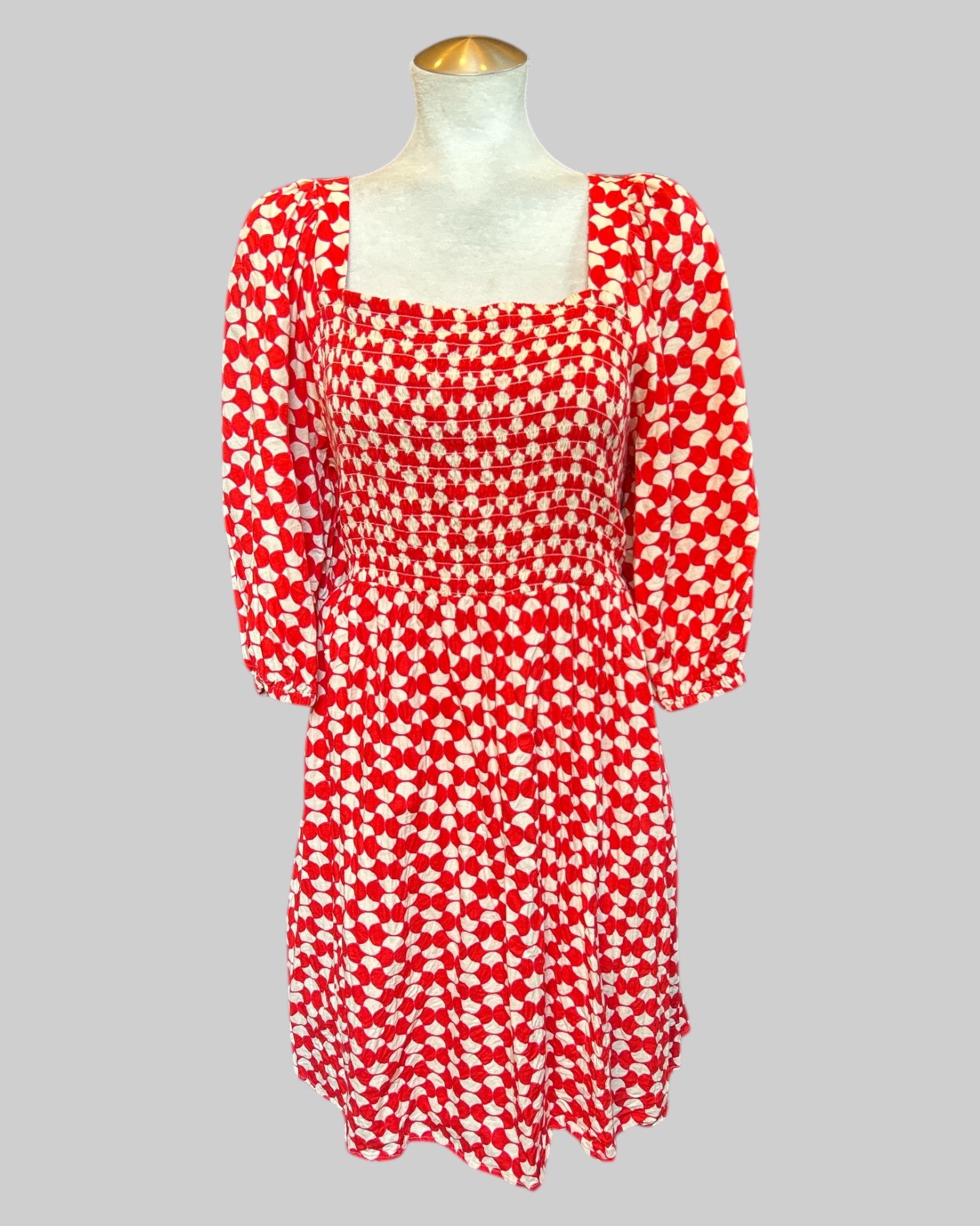 1X stretchy flowy red white geometric patterned dress with shirring in front and back, balloon sleeves, and pockets