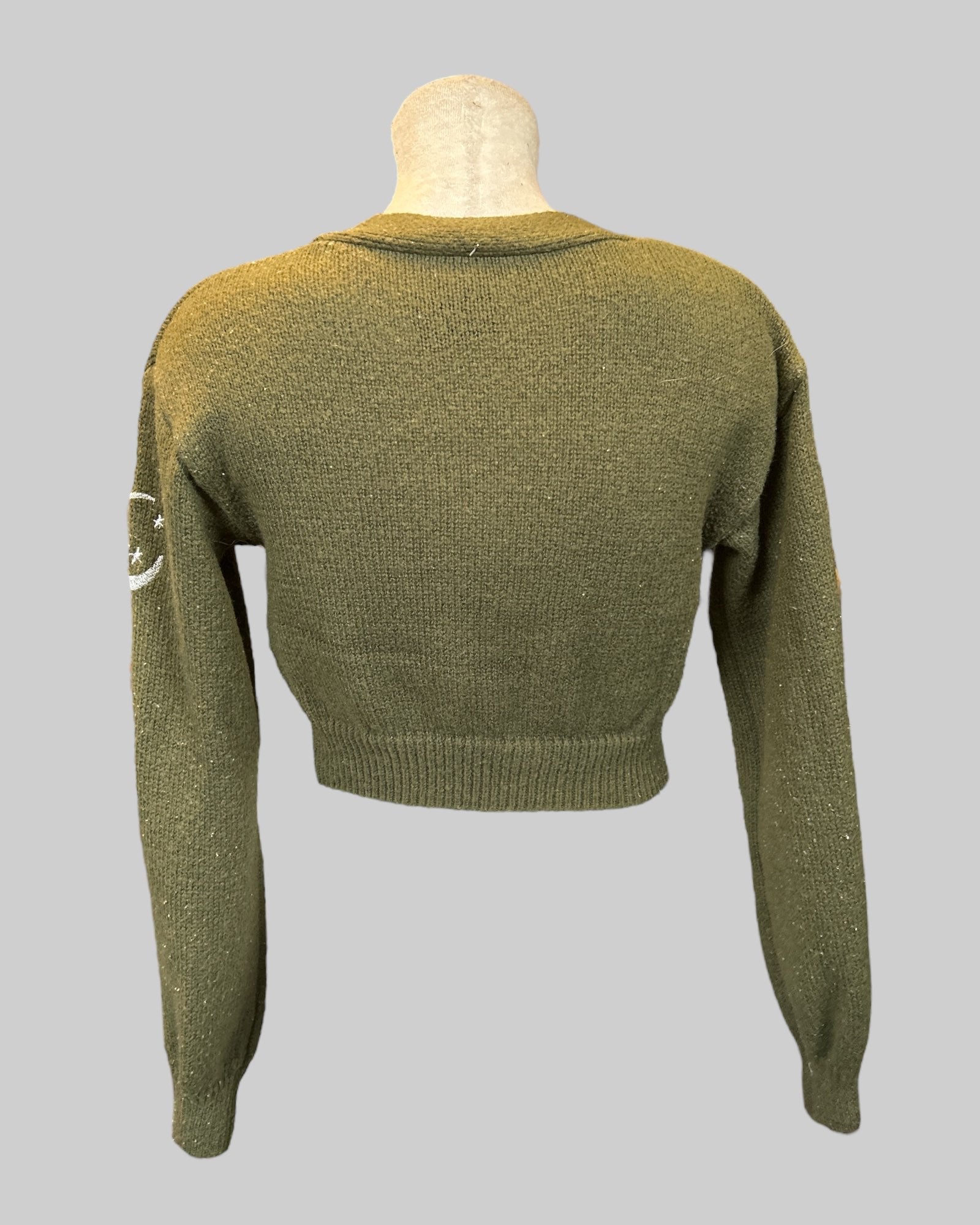 M green knit cardigan with moon, suns, stars, and leaves
