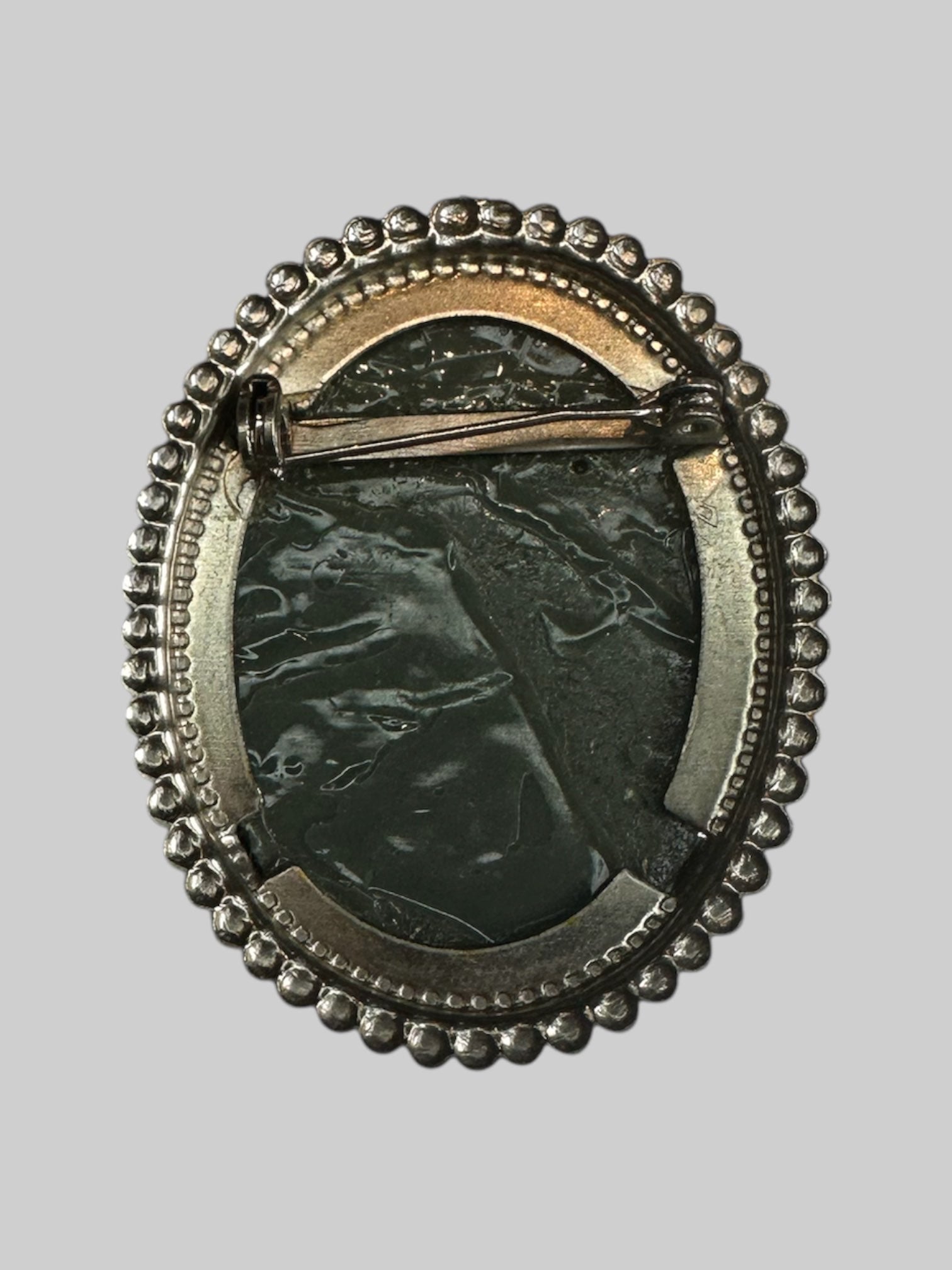 Vintage Dark green cameo brooch with silver like frame and safety pin style backing