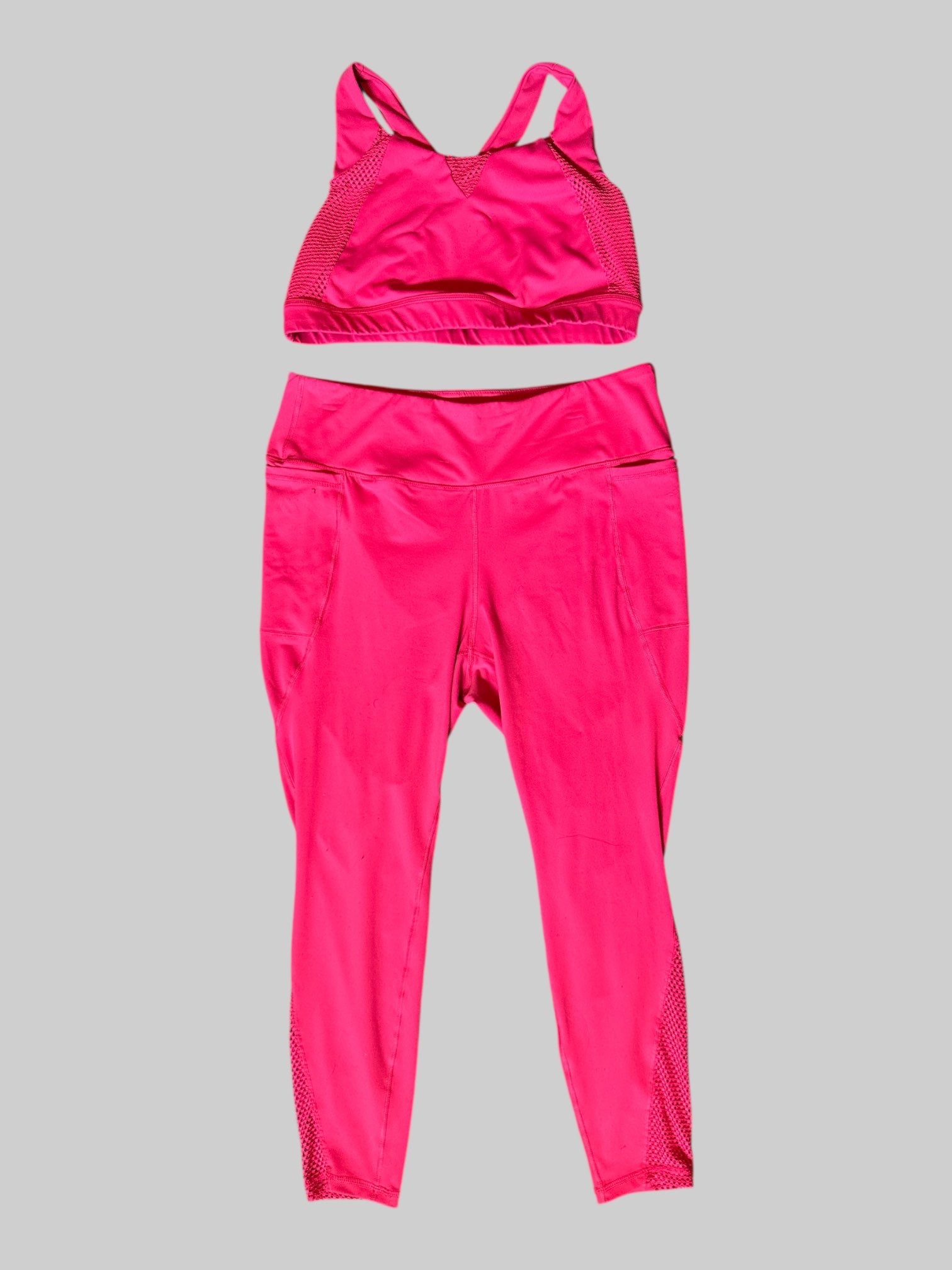 2x pink stretchy two piece athletic suit, has pockets and stretch