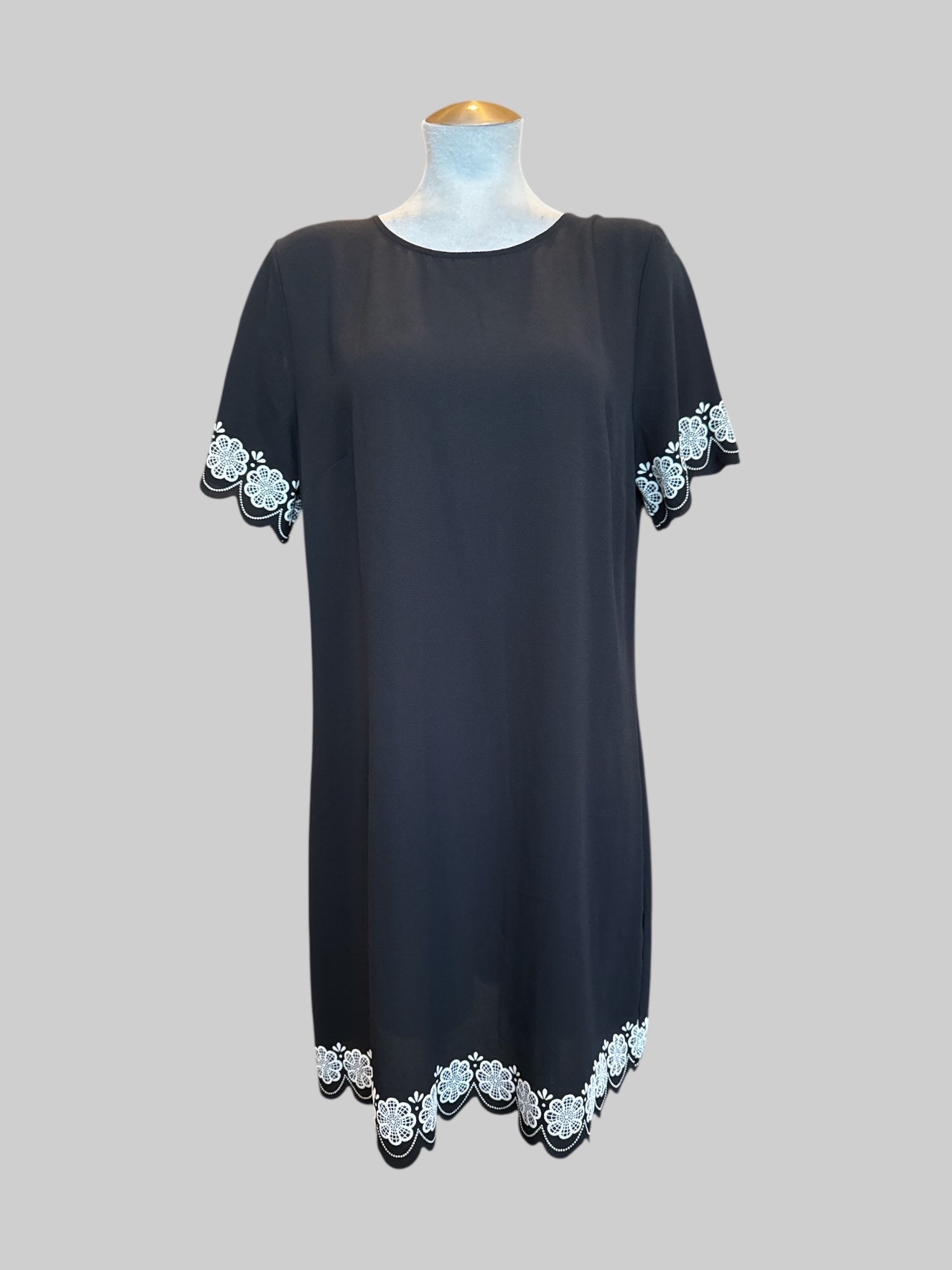 L black shift mini dress with floral details and scalloped hem